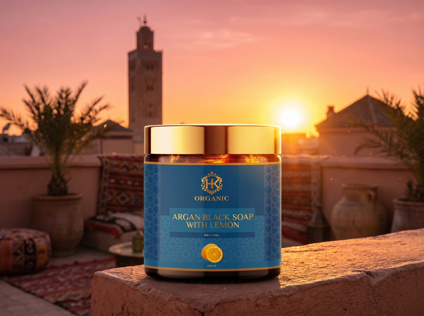 Jar of argan black soap with lemon on a rooftop at sunset