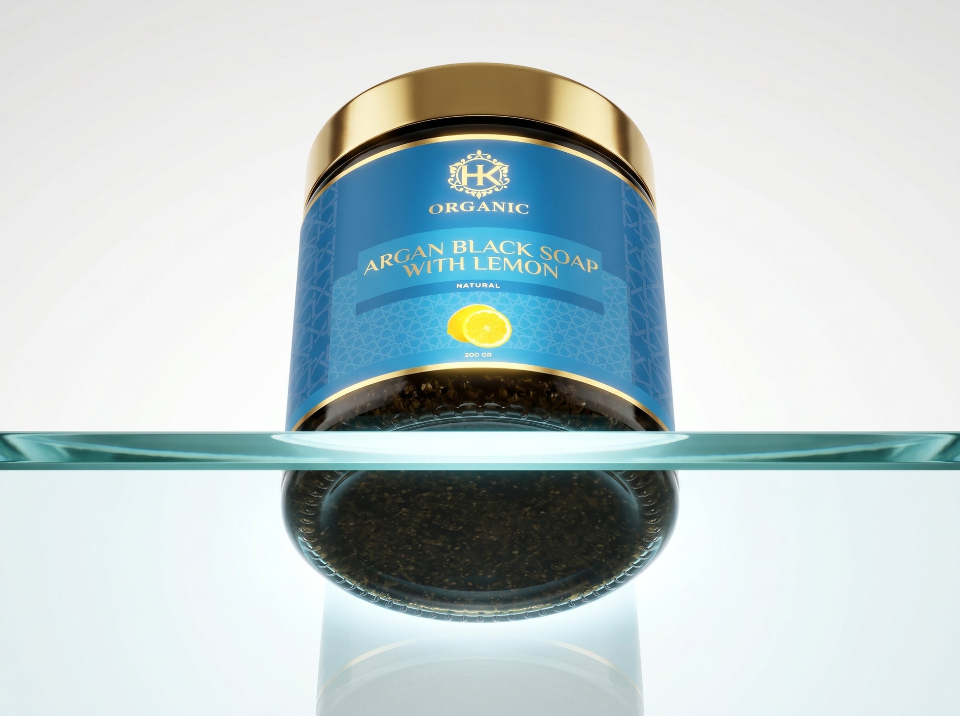 Jar of argan black soap with lemon on a reflective surface