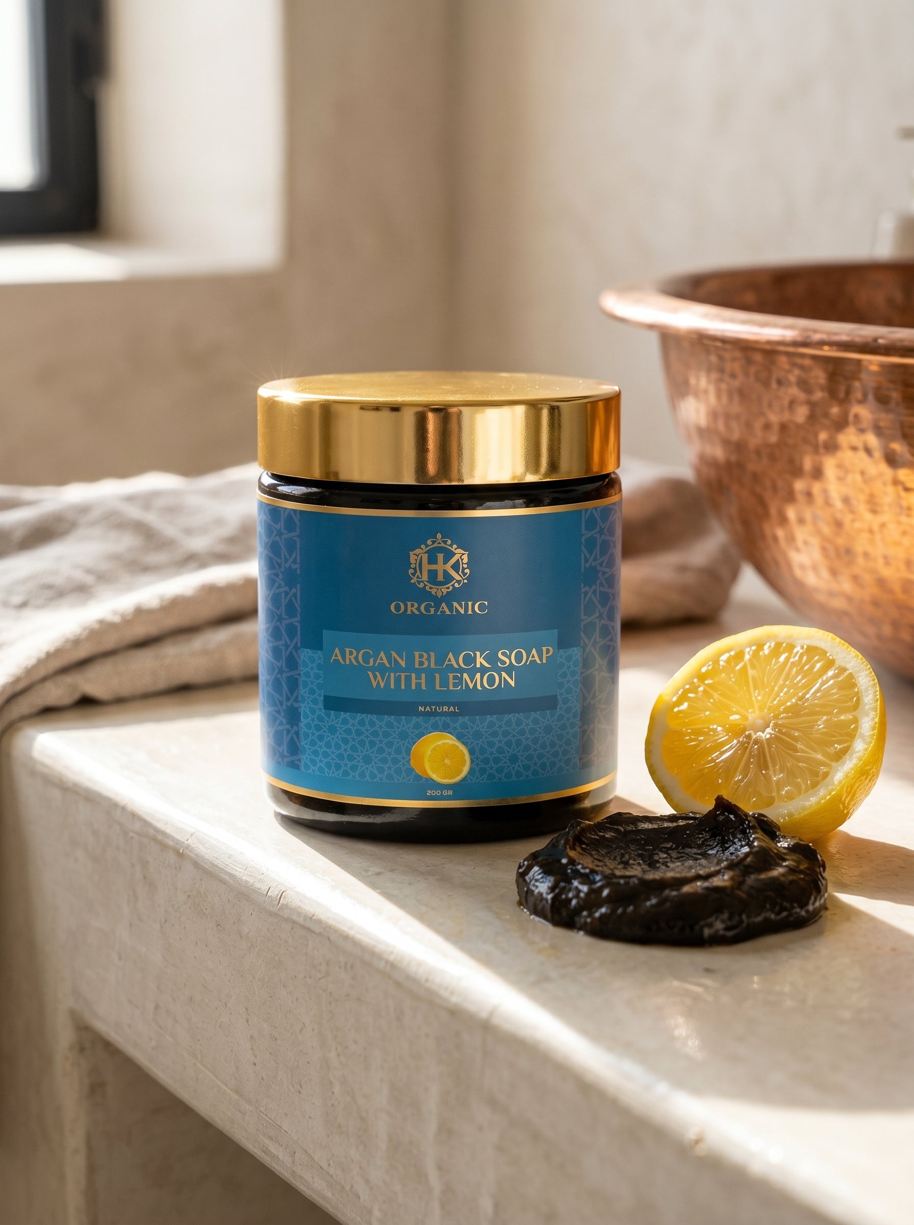 Jar of argan black soap with lemon on a bathroom counter