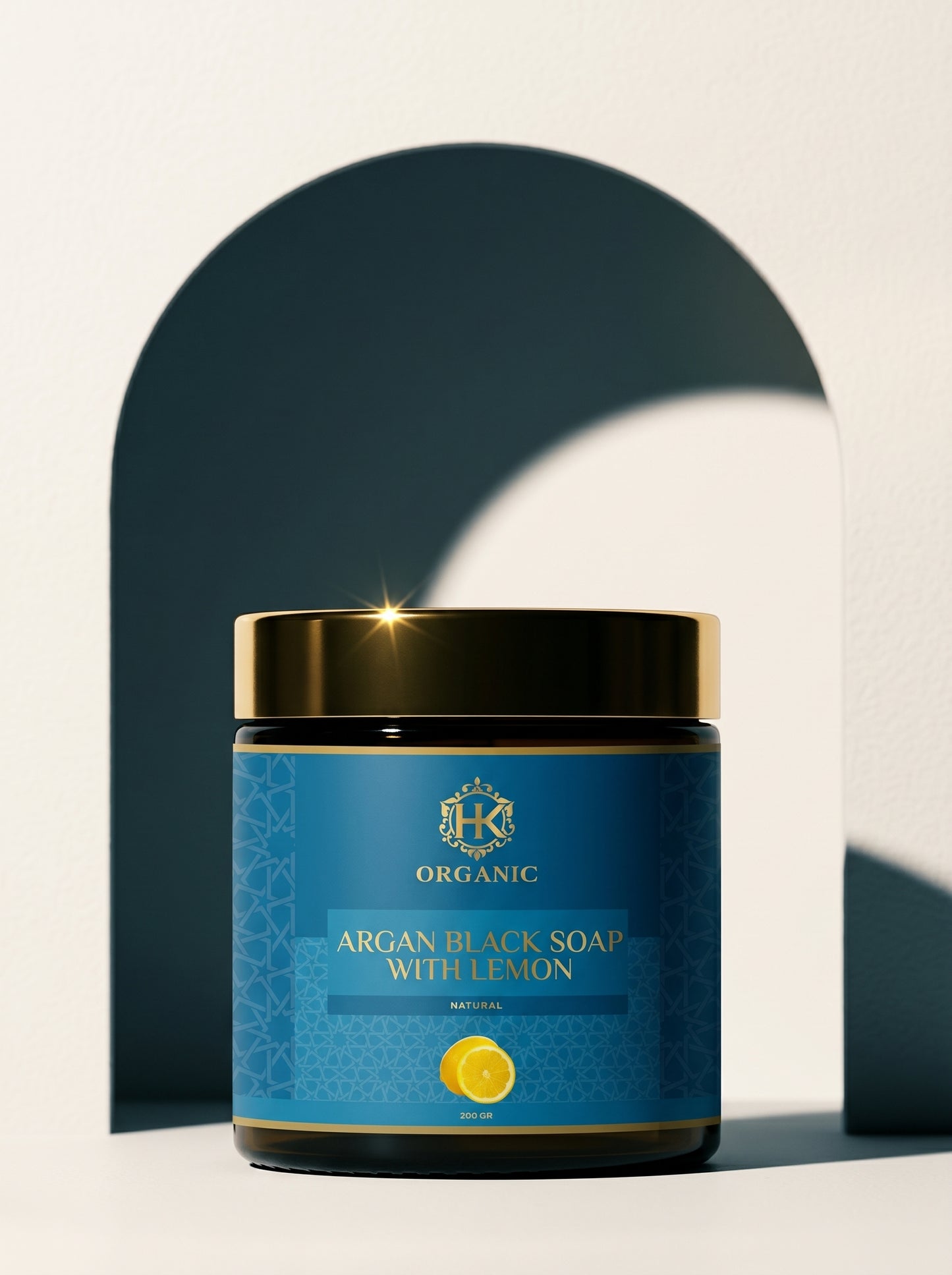 Jar of argan black soap with lemon on a light background