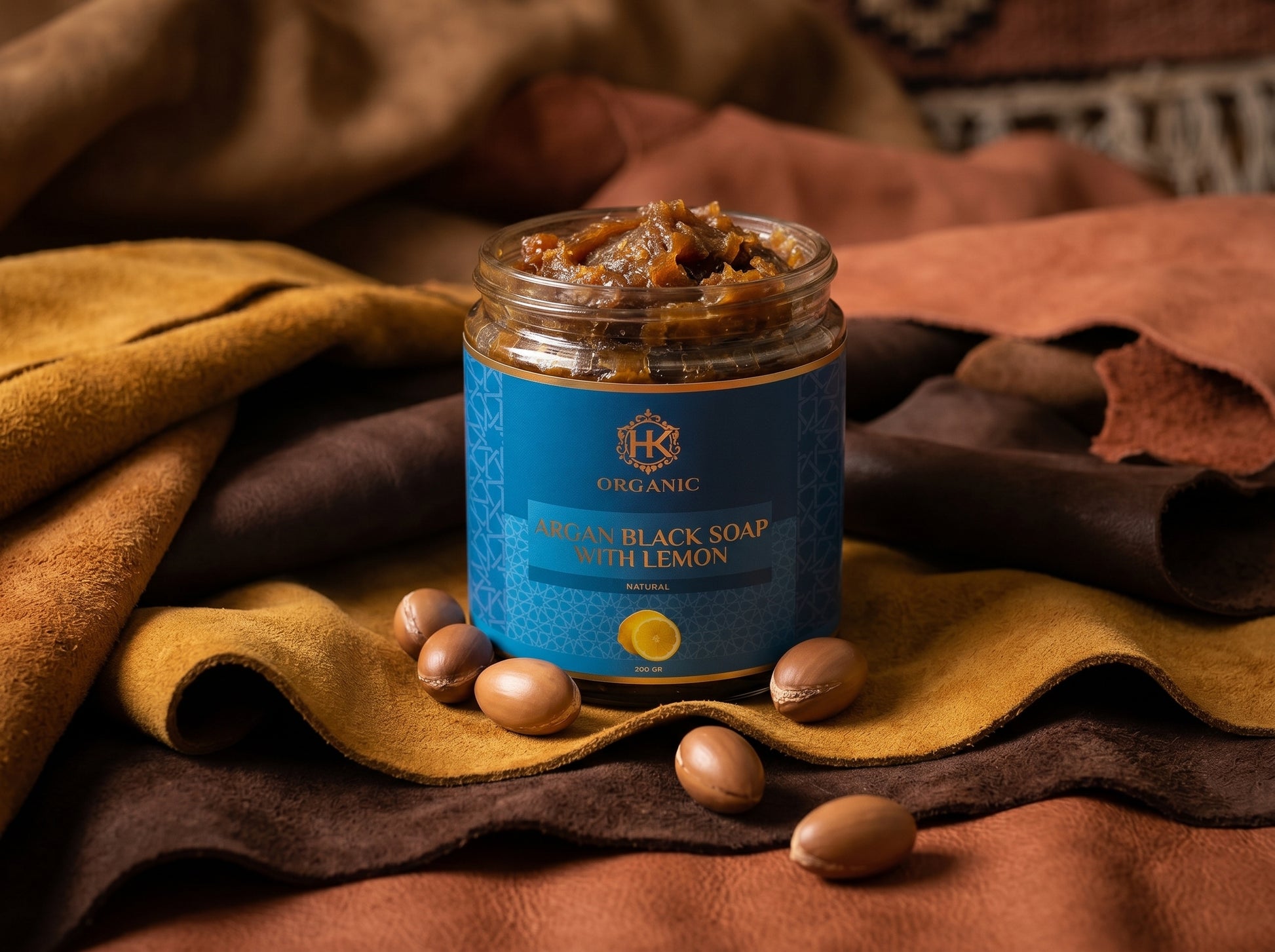 Jar of organic black soap with lemon on a textured fabric background
