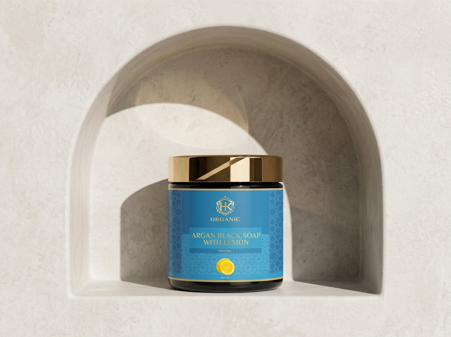Jar of argan black soap with lemon on a neutral background