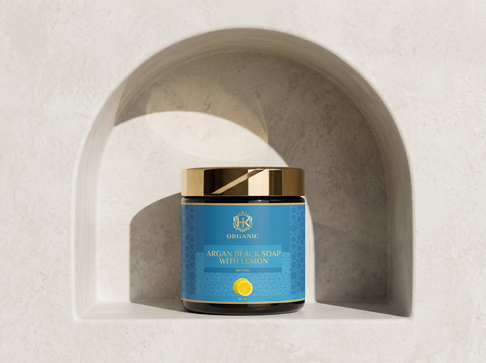 Jar of argan black soap with lemon on a neutral background