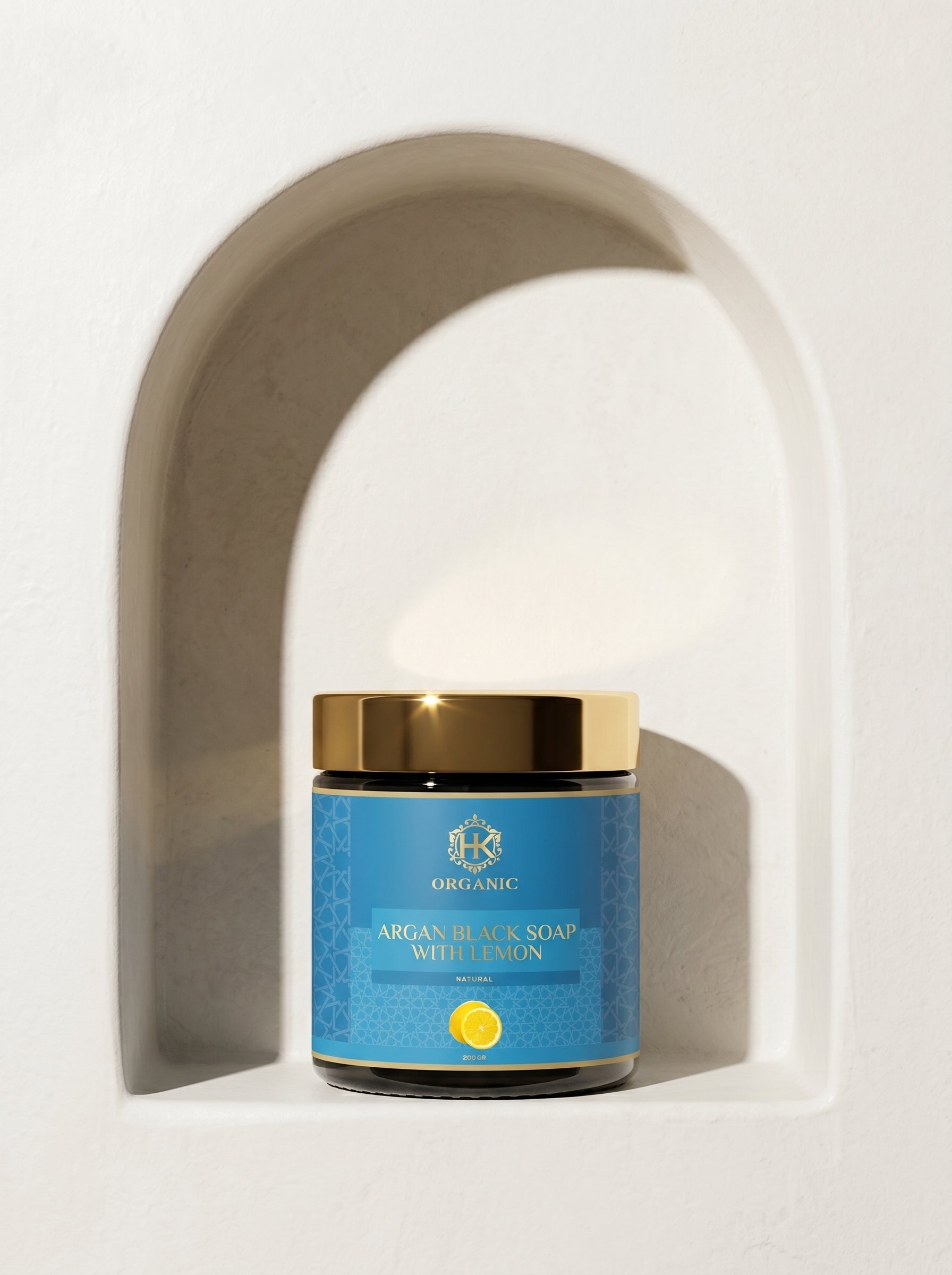 Jar of argan black soap with lemon on a white background