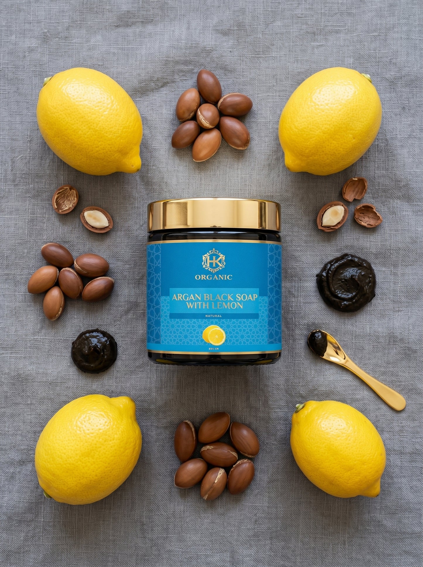 Argan black soap with lemons and nuts on a gray surface