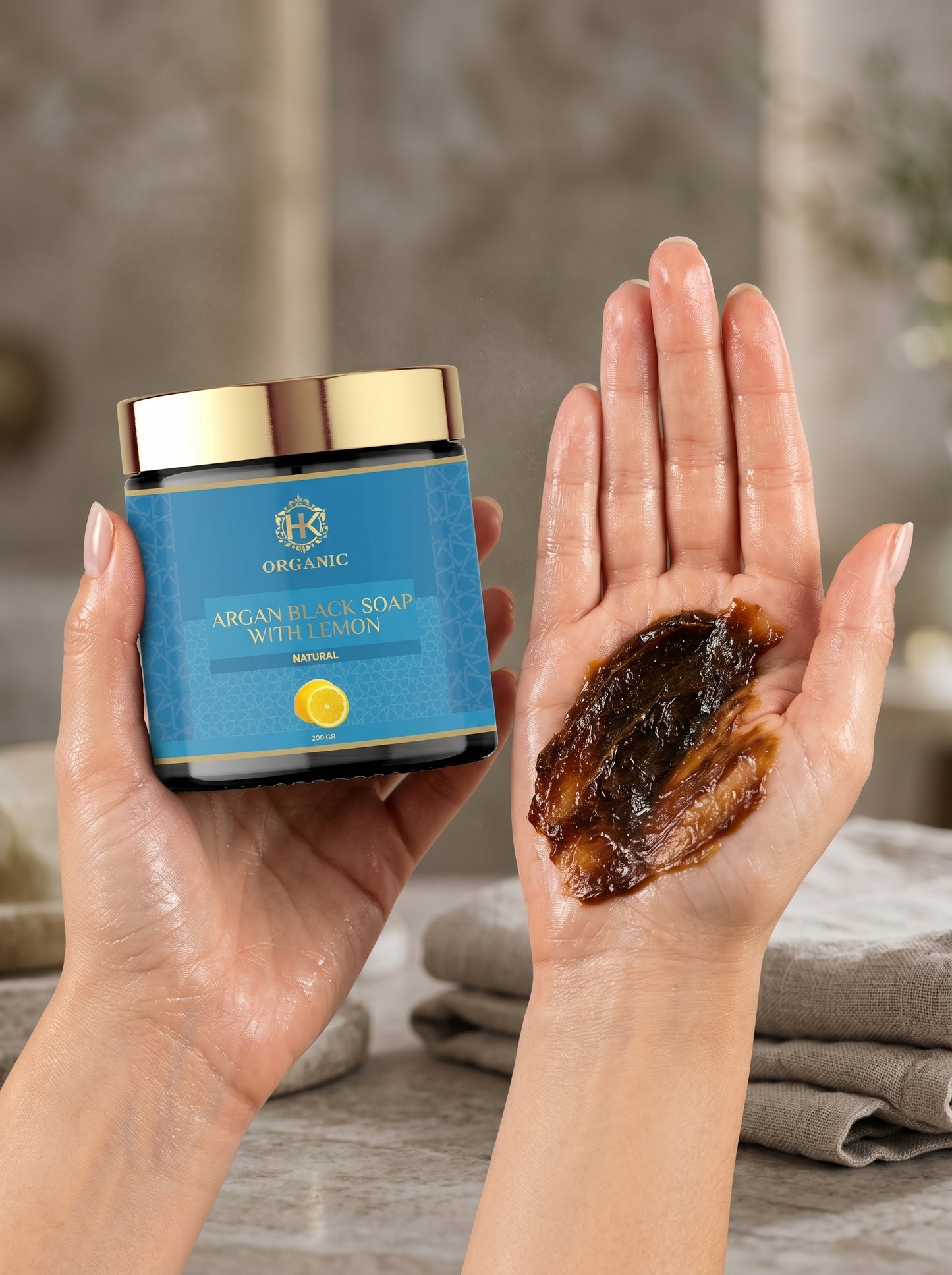 Jar of Argan Face Soap with Lemon held by a hand, showing soap on another hand.