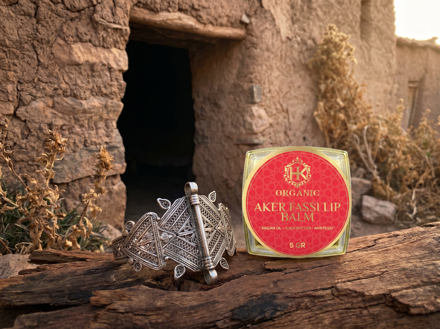 Silver ring and Aker Fasslip lip balm on a stone surface with a rustic background