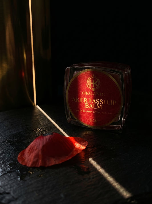 Lip balm with red label on a dark surface