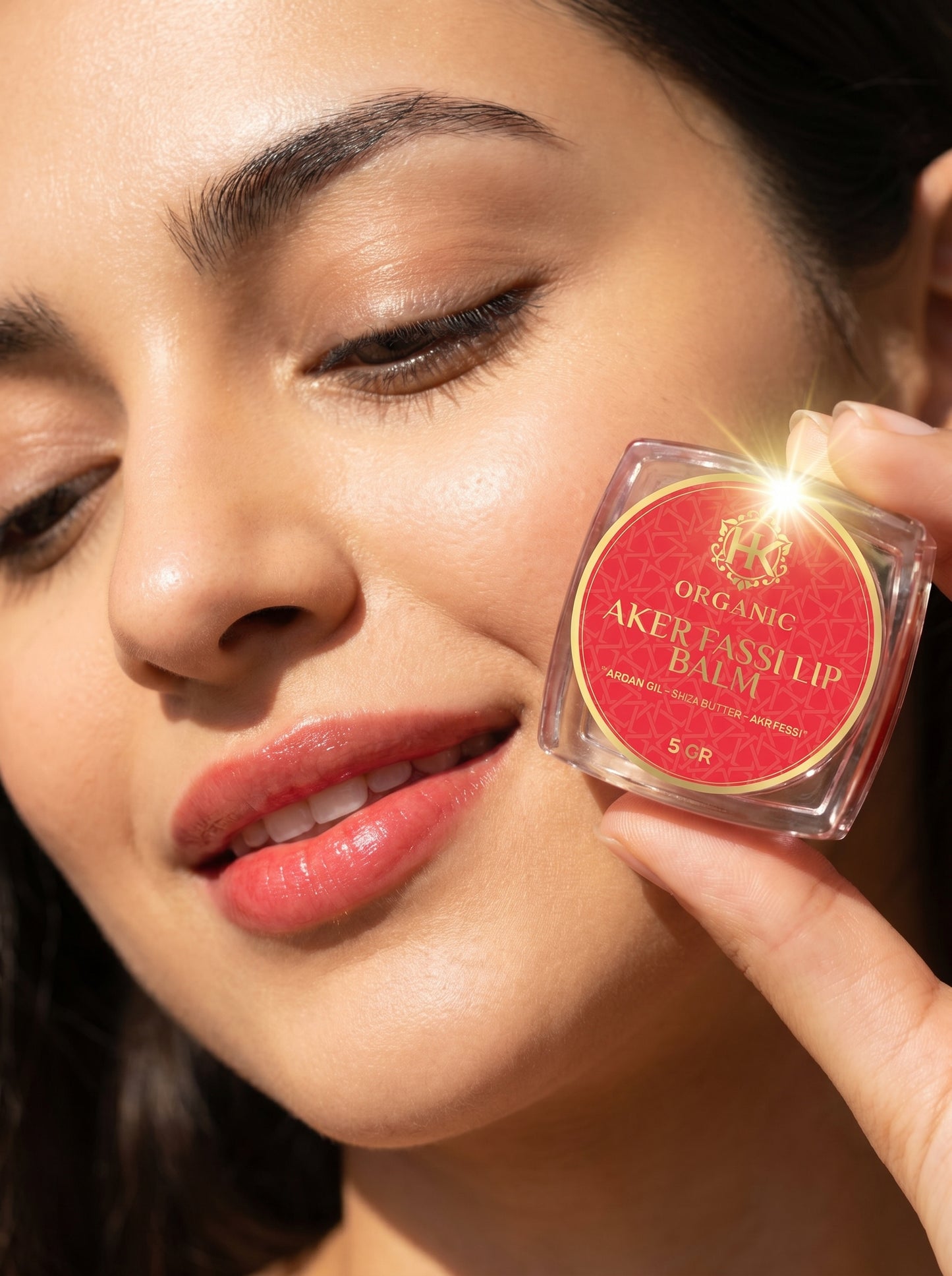 Woman holding a lip balm close to her face