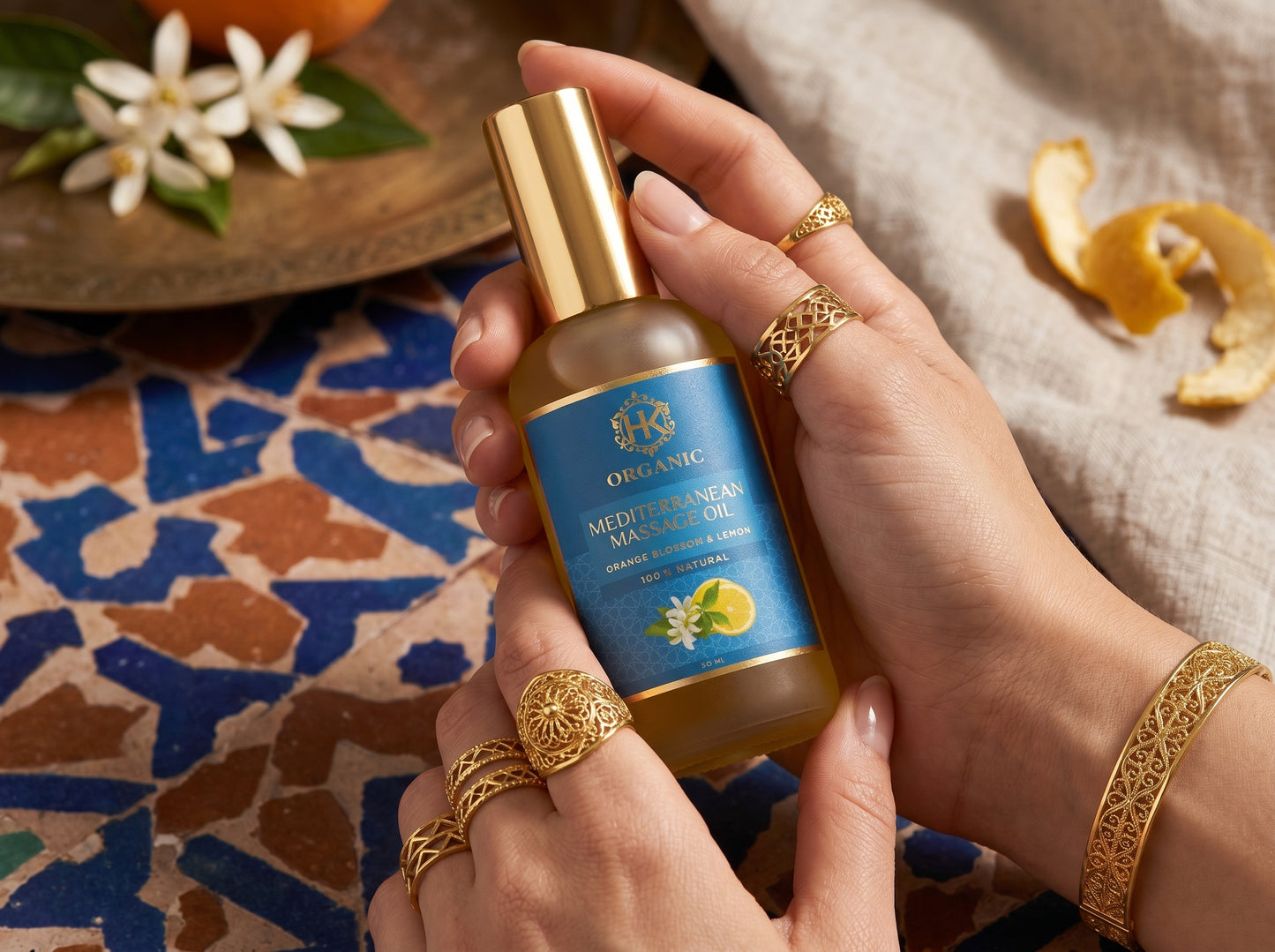 Hand holding a bottle of Oriflame skincare product with decorative elements in the background