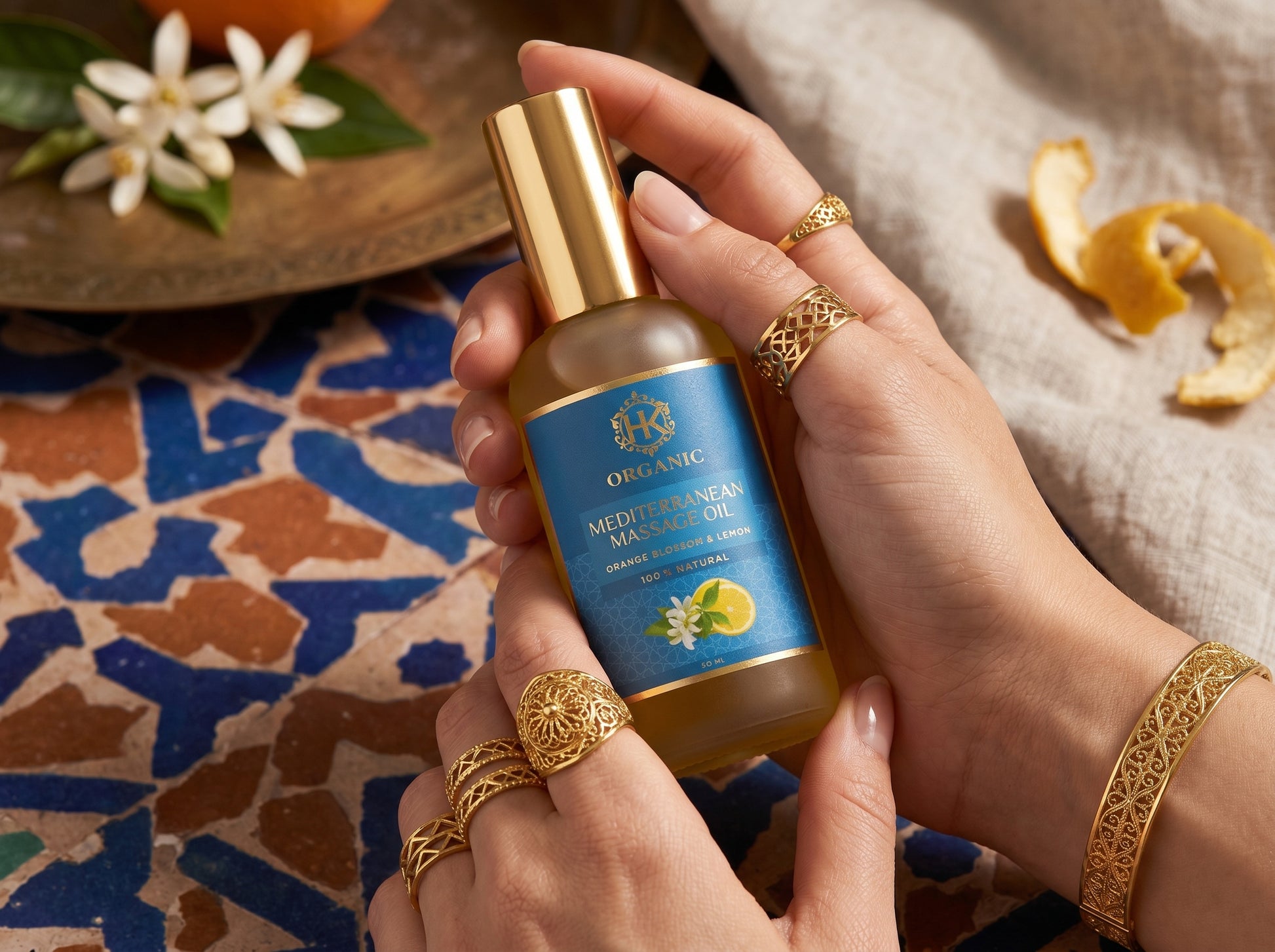 Hand holding a bottle of Oriflame skincare product with decorative elements in the background