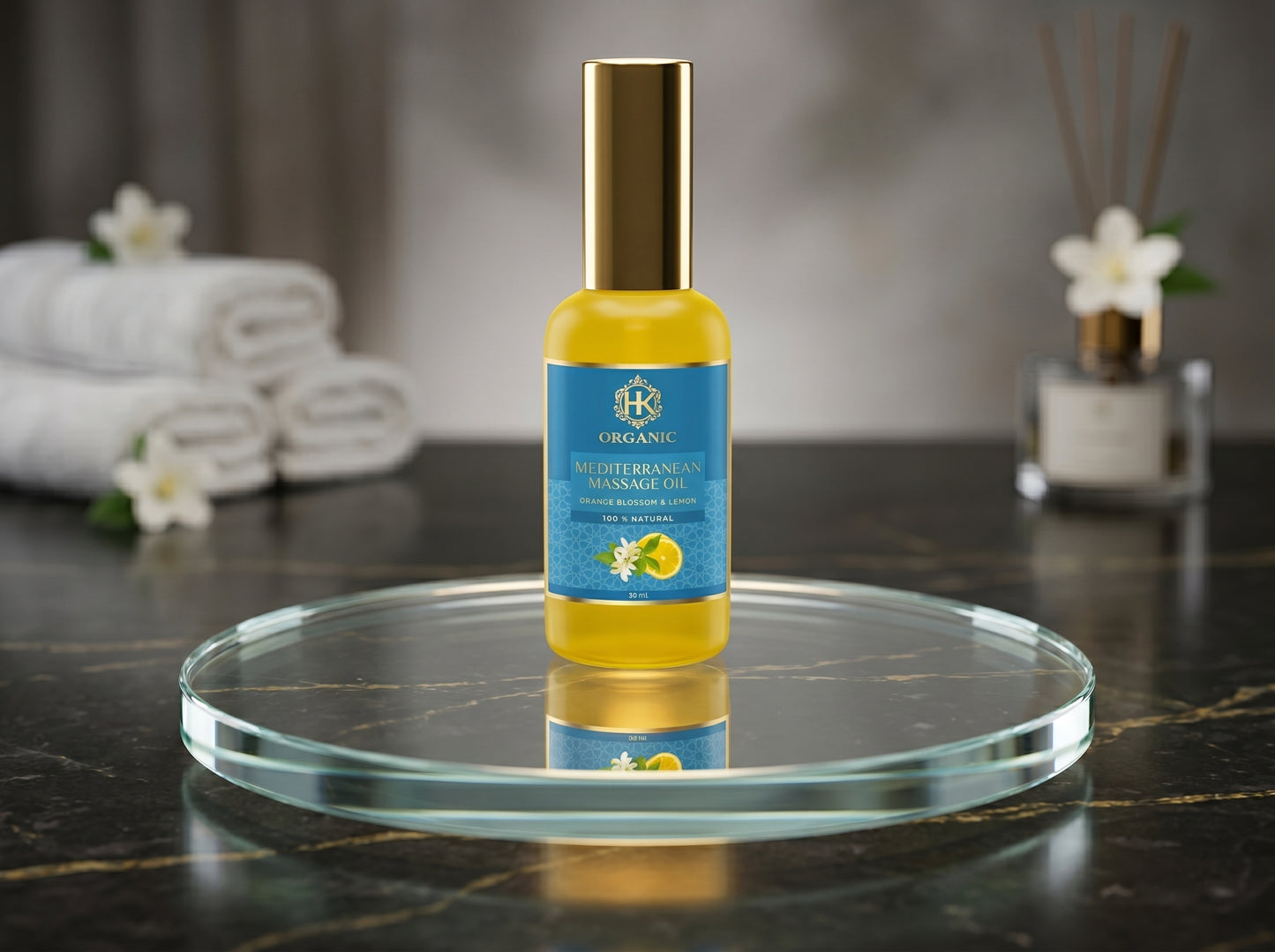 Massage oil bottle on a round glass tray with towels and diffuser in the background
