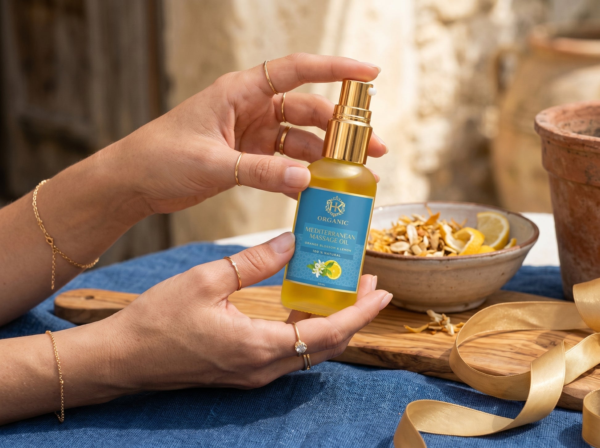 Person holding a bottle of Goshin Jigokudan skincare product with a bowl of ingredients in the background.