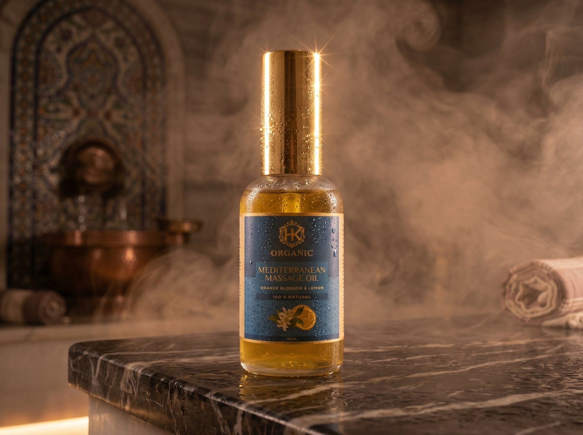 Bottle of organic Mediterranean olive oil on a marble surface with a decorative background