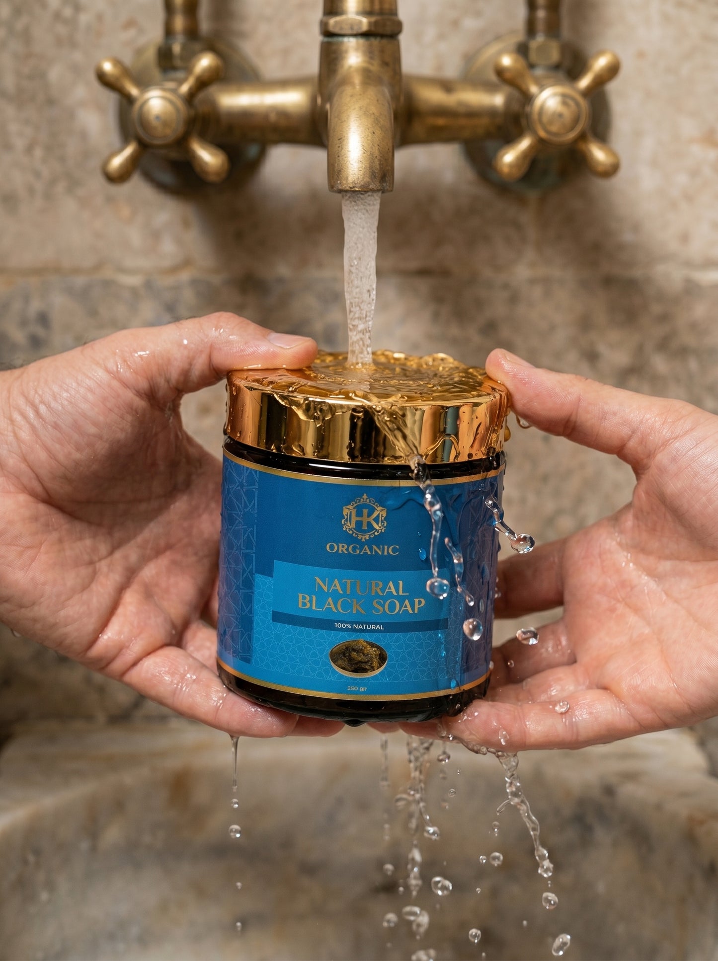Person holding a jar of natural black soap under running water from a faucet.