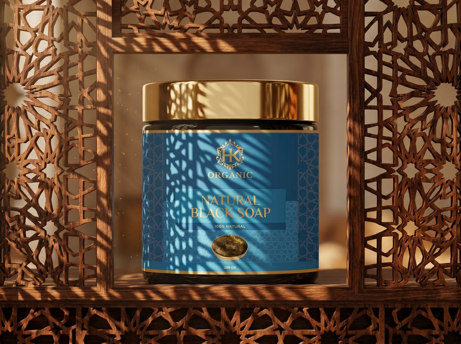 Blue jar of natural black soap with gold lid on a decorative wooden shelf