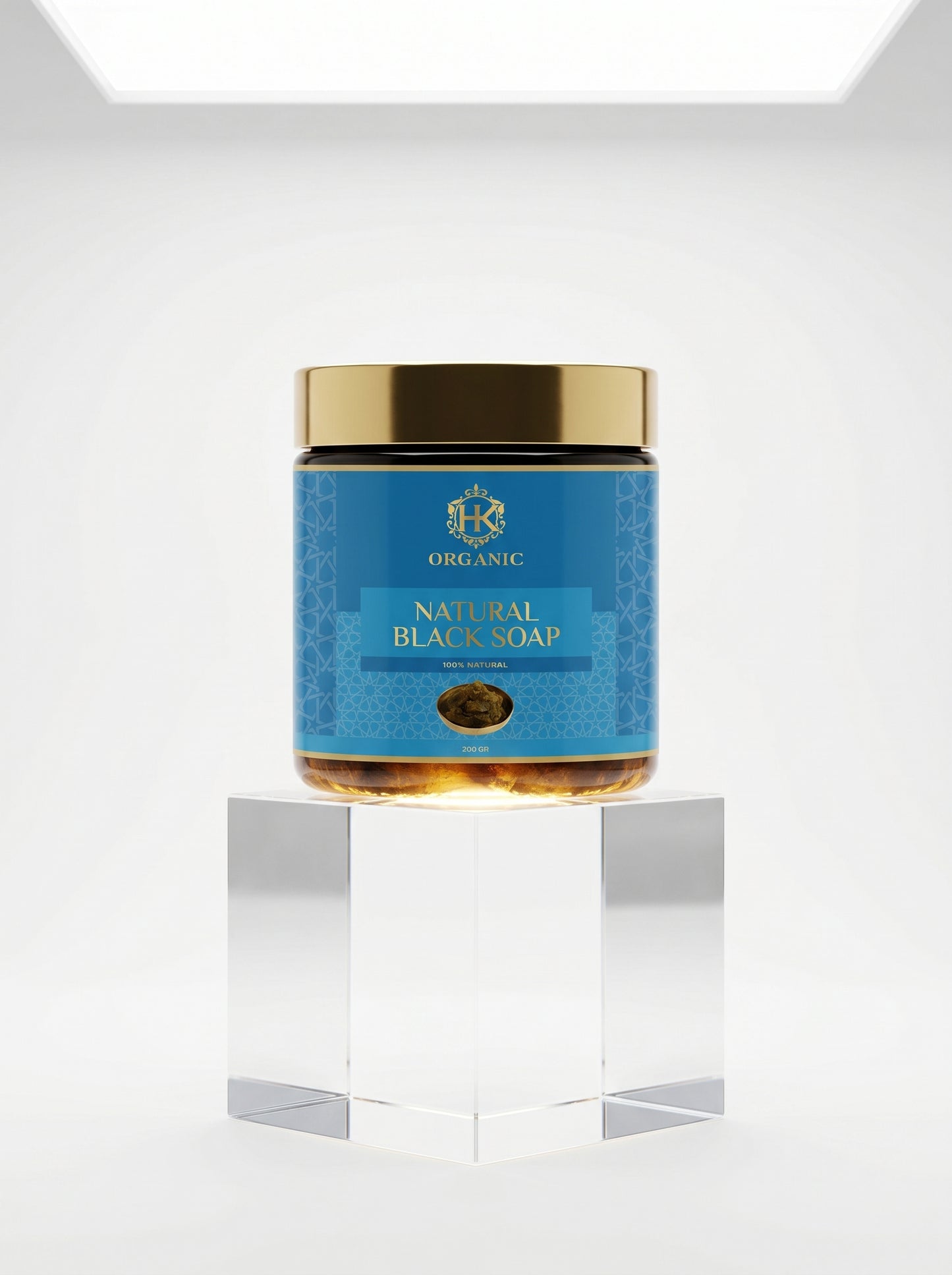 Jar of natural black soap with a blue label on a white background