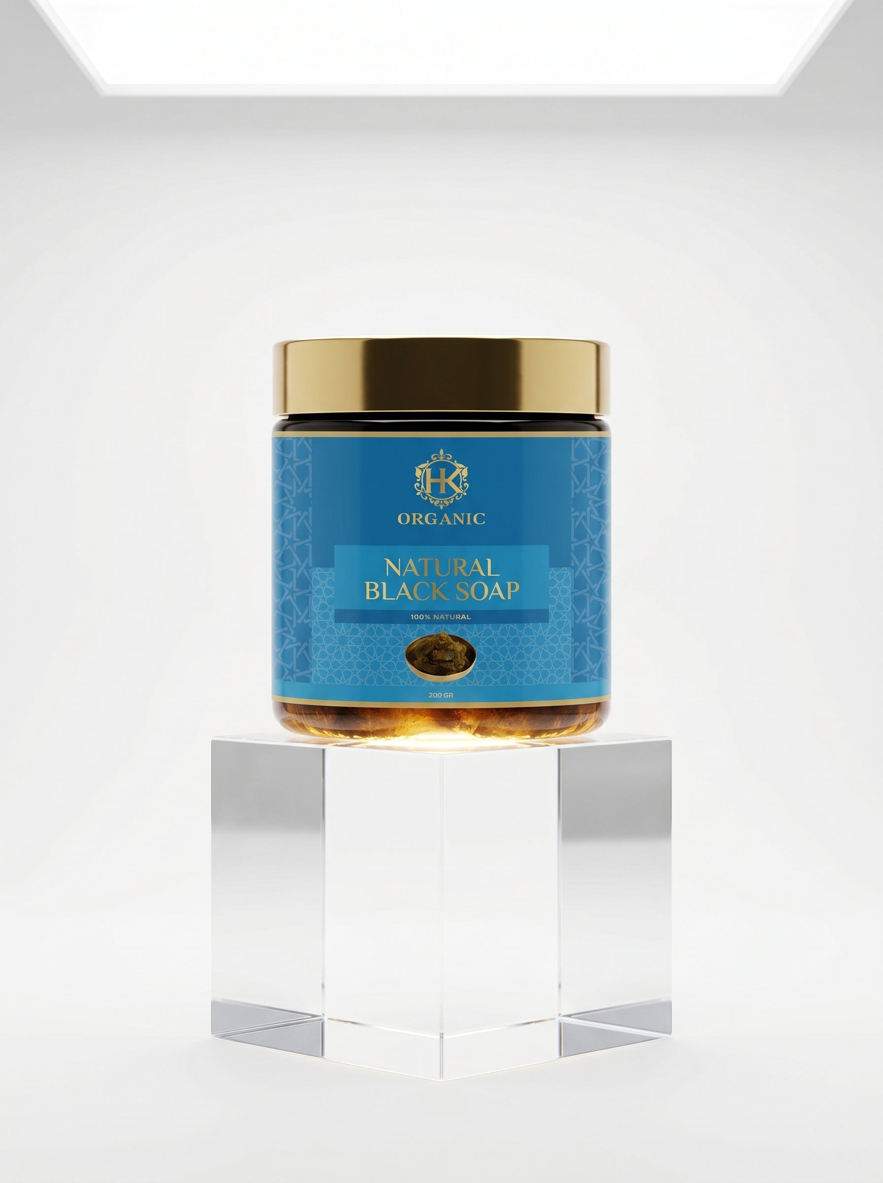 Jar of natural black soap with a blue label on a white background