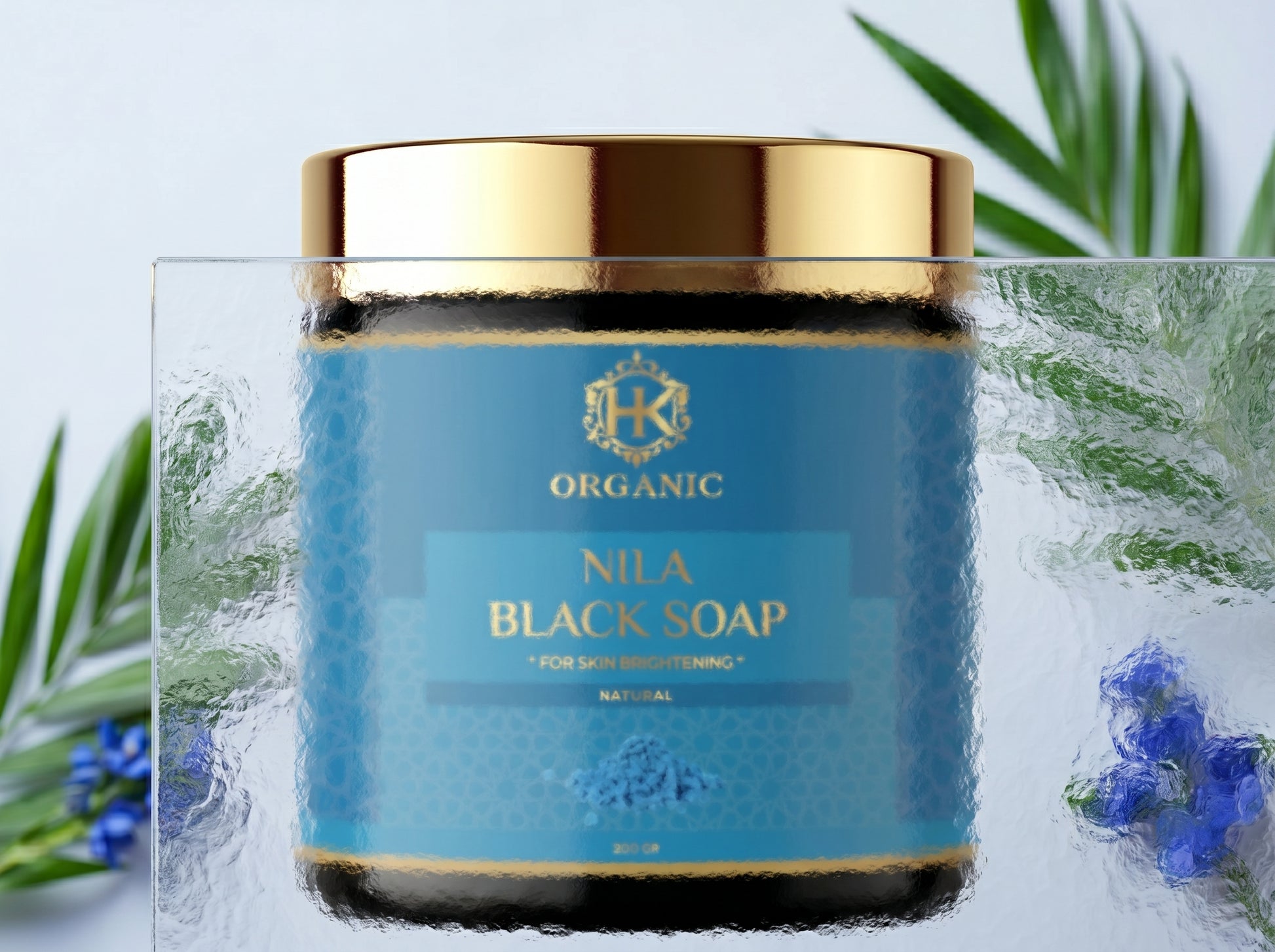 Nila Black Soap jar with gold lid on a light background