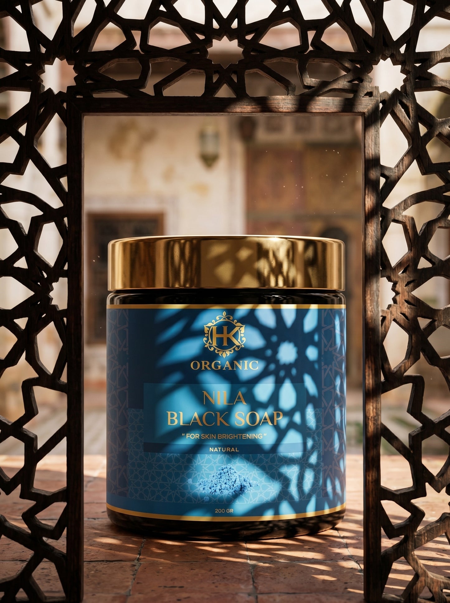 Container of Nia Black Soap with decorative metal frame