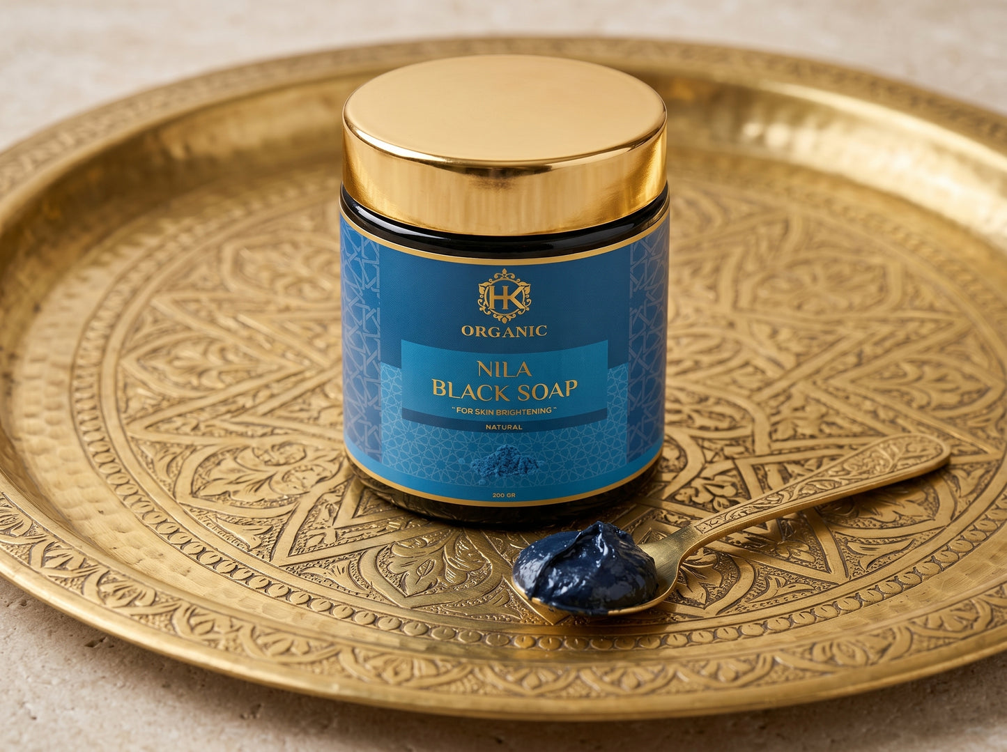 Nila Black Soap jar with blue label on a gold tray