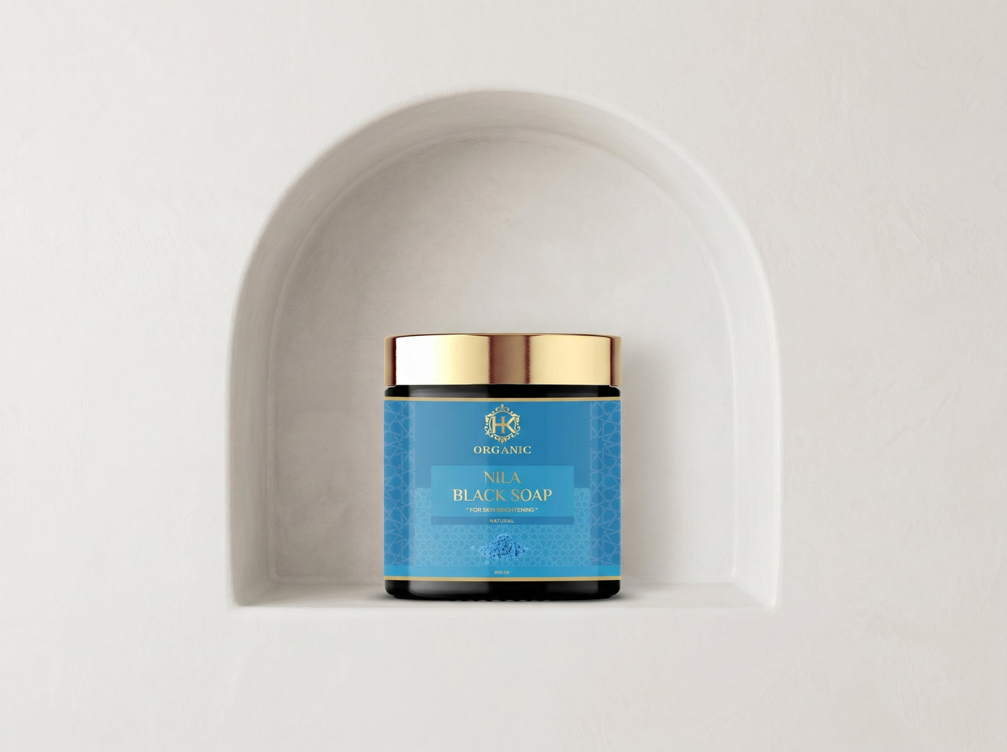 Jar of soap with blue label and gold lid on a white background