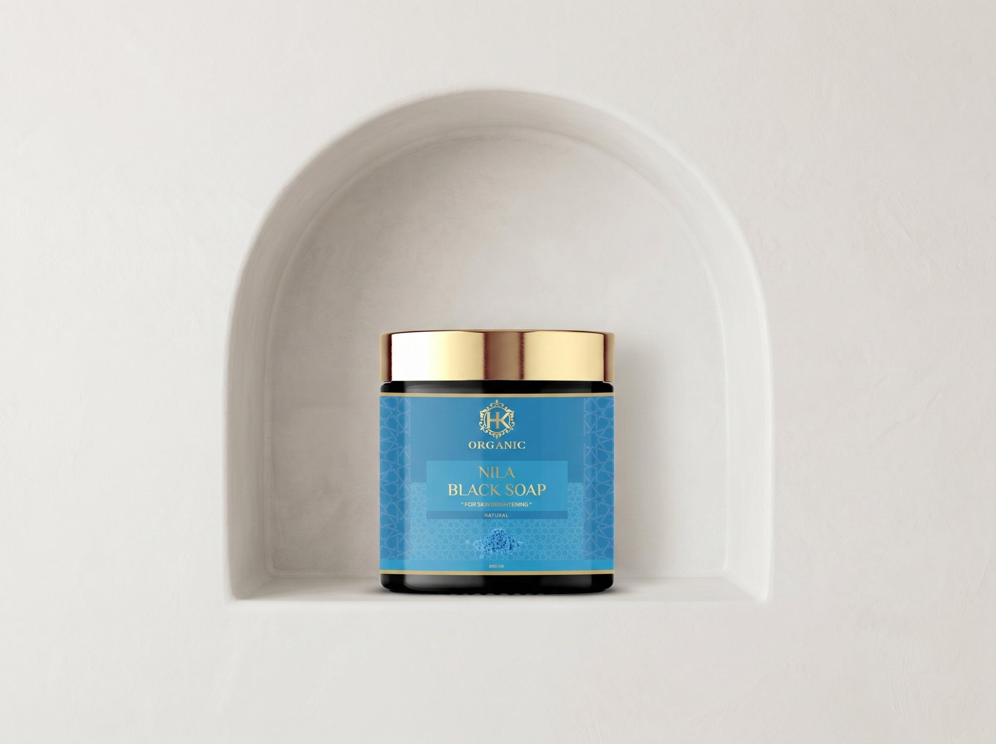 Jar of soap with blue label and gold lid on a white background