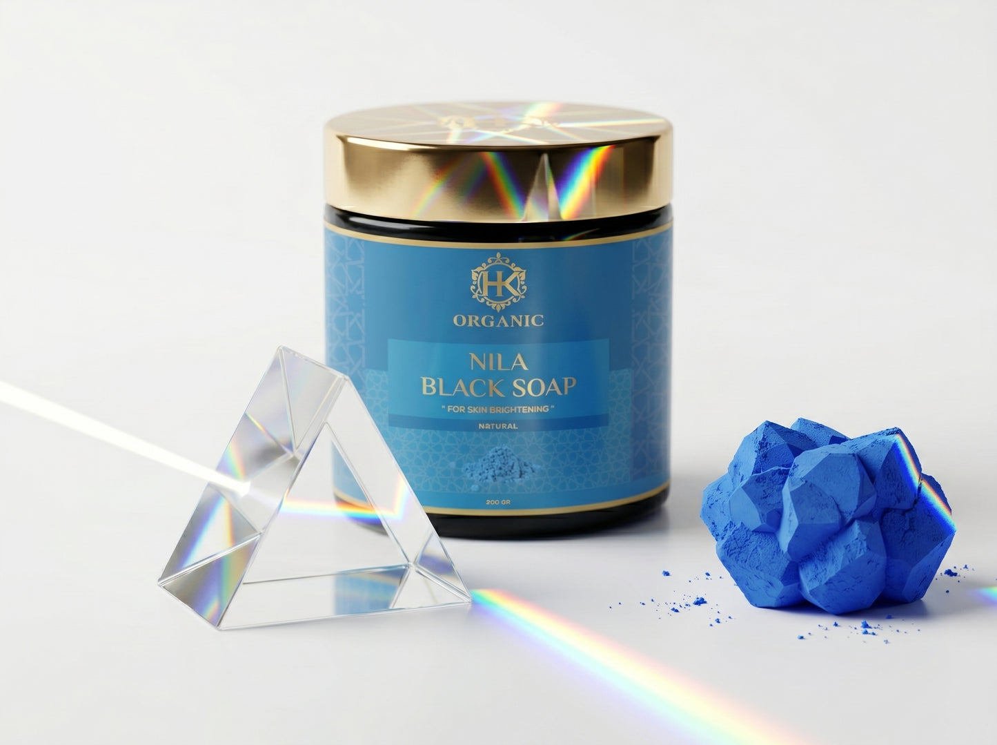 Blue jar of Nila Black Soap with a crystal and soap bar on a white background