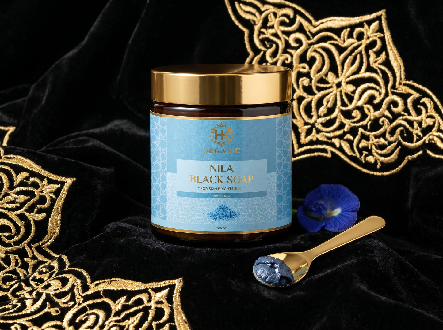 Nila Black Soap jar with blue label on a black background with gold patterns