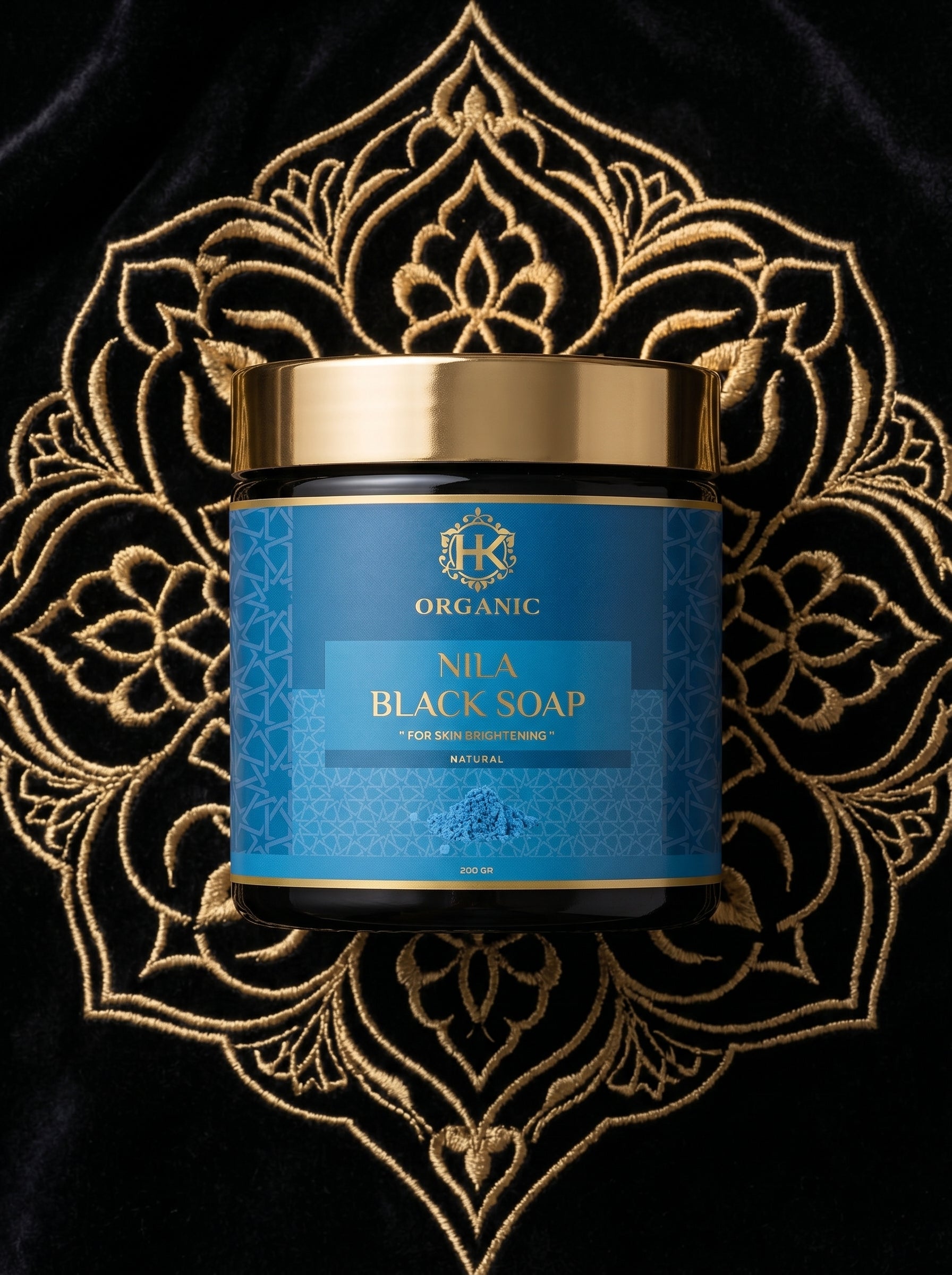 Jar of Nila Black Soap with decorative gold pattern on a black background