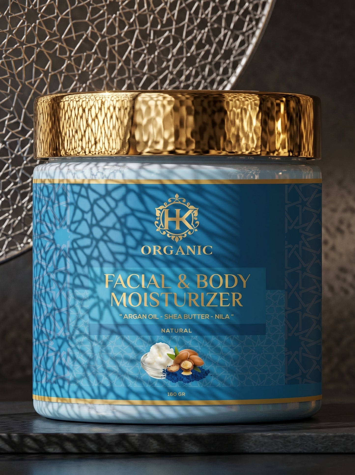 Facial and body moisturizer jar with gold lid on a textured surface