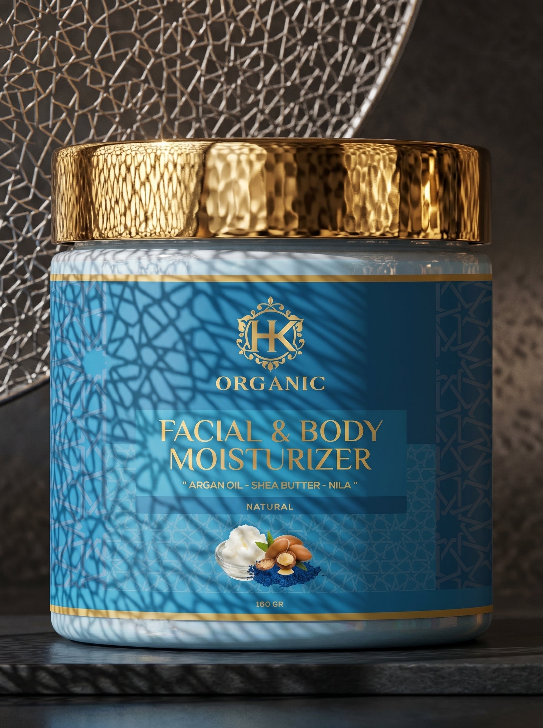 Facial and body moisturizer jar with gold lid on a textured surface