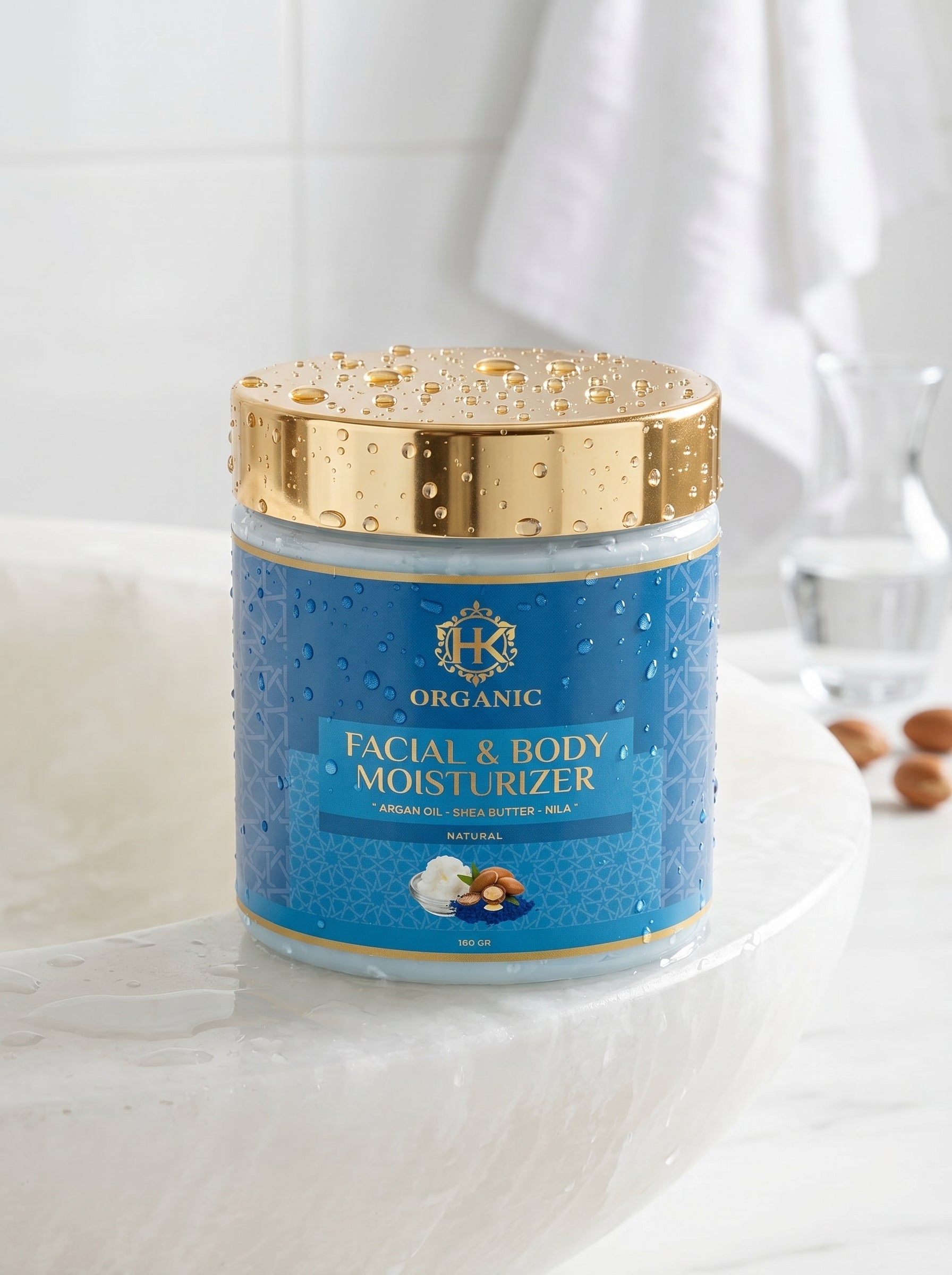 Facial and body moisturizer jar with gold lid on a white background