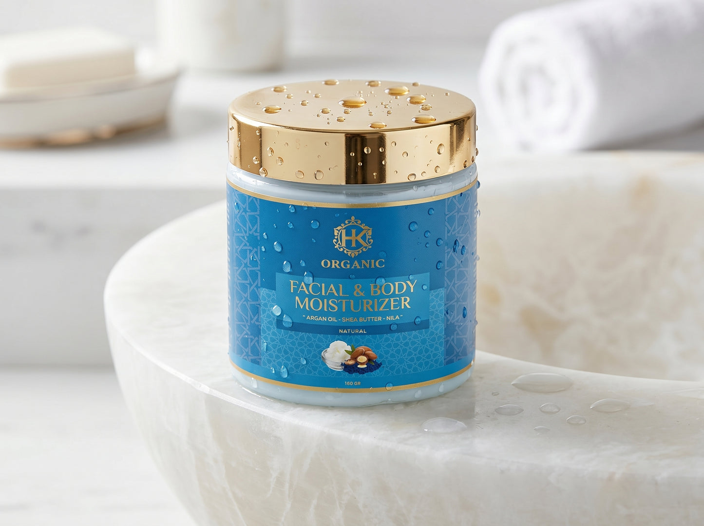 Facial and body moisturizer jar with gold lid on a marble surface