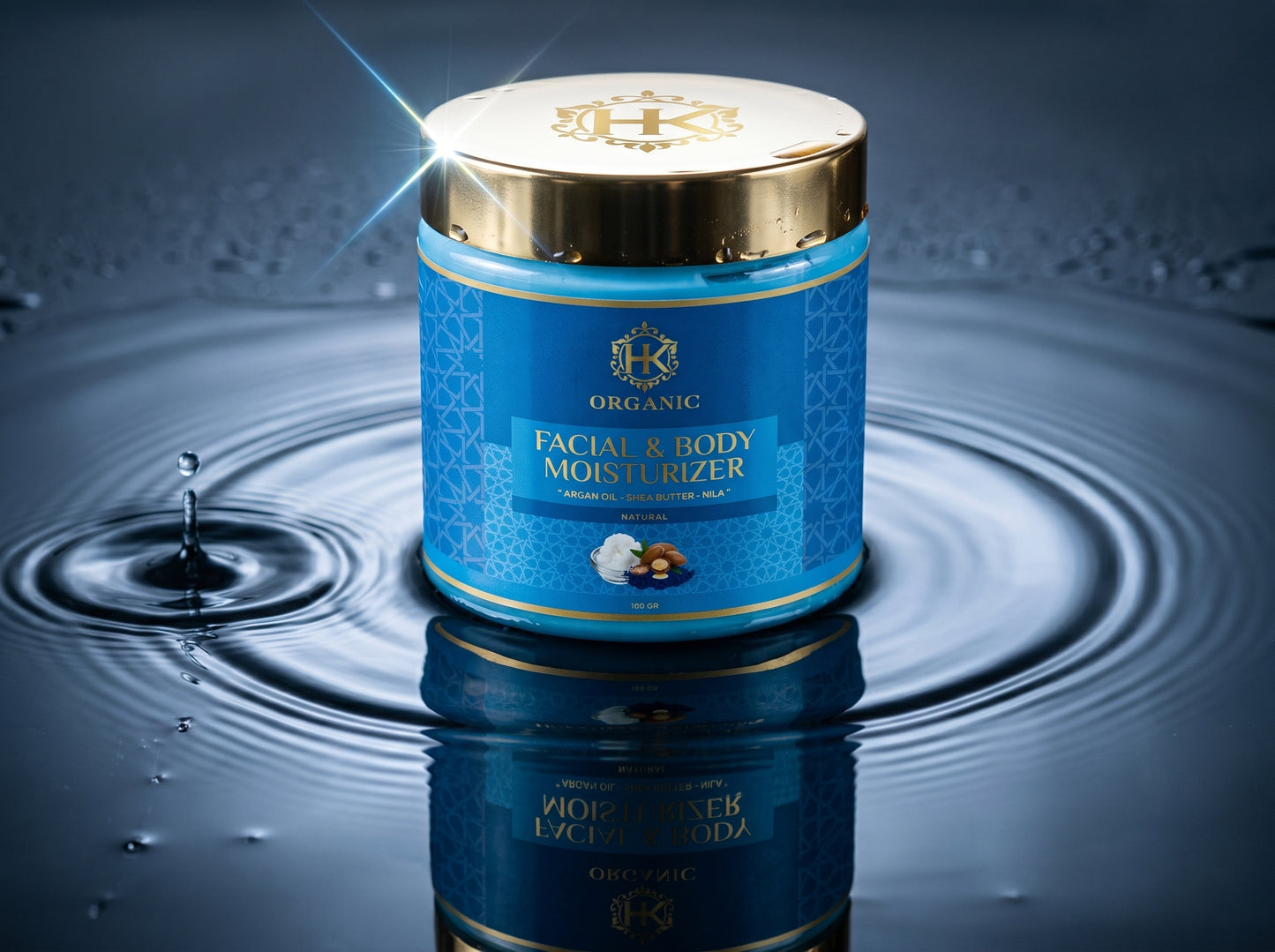 Blue jar of facial and body moisturizer with gold lid on a reflective water surface