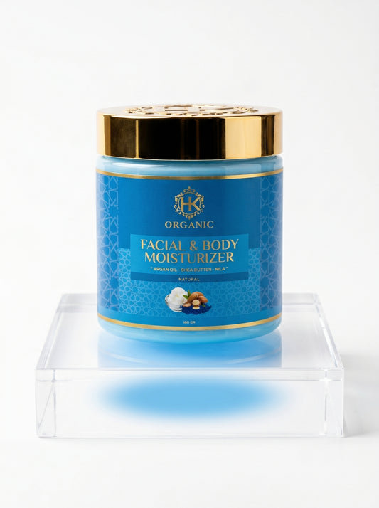 Blue jar of facial and body moisturiser with gold lid on a white background