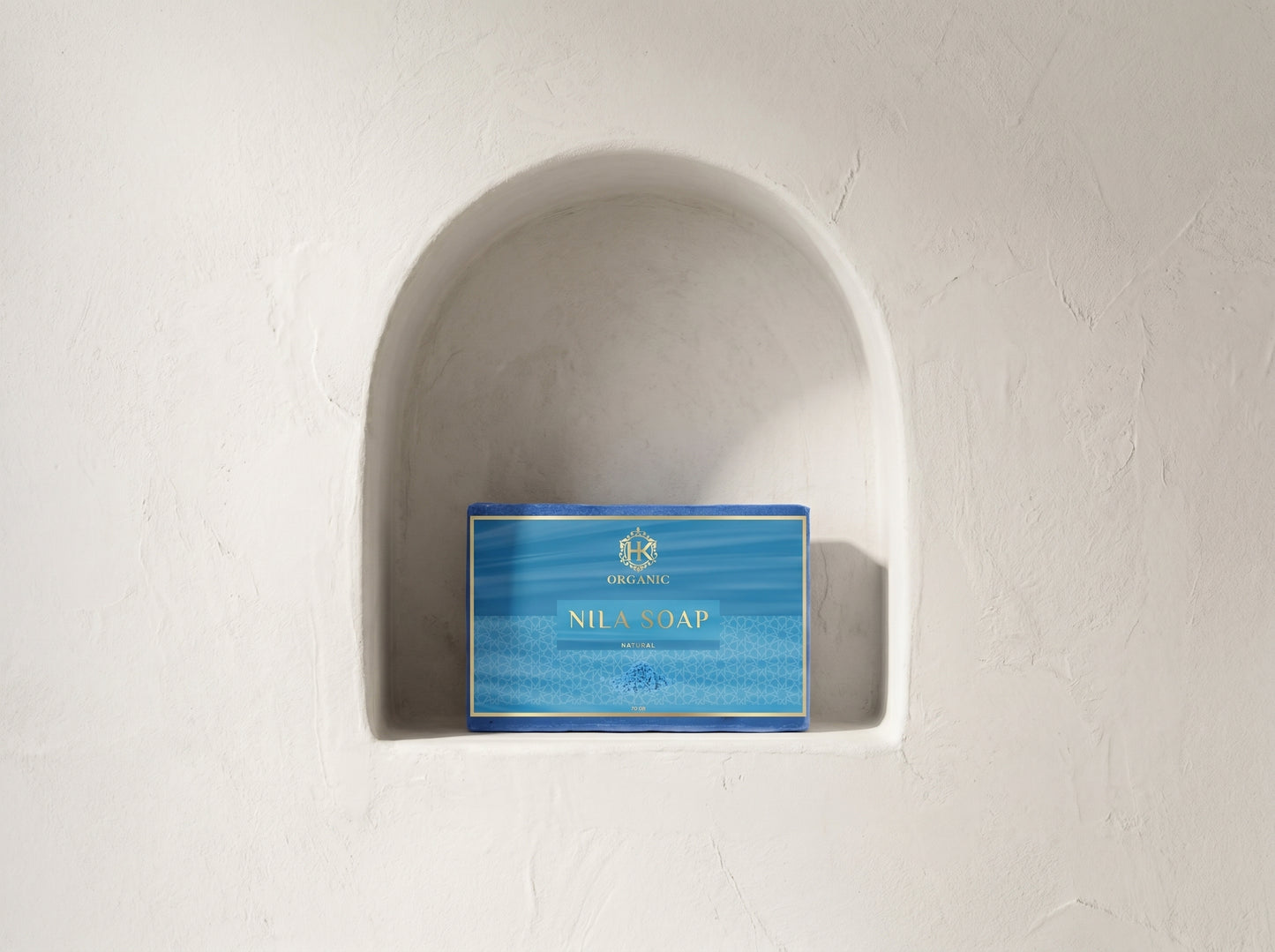 Blue soap packaging on a white wall with a decorative arch