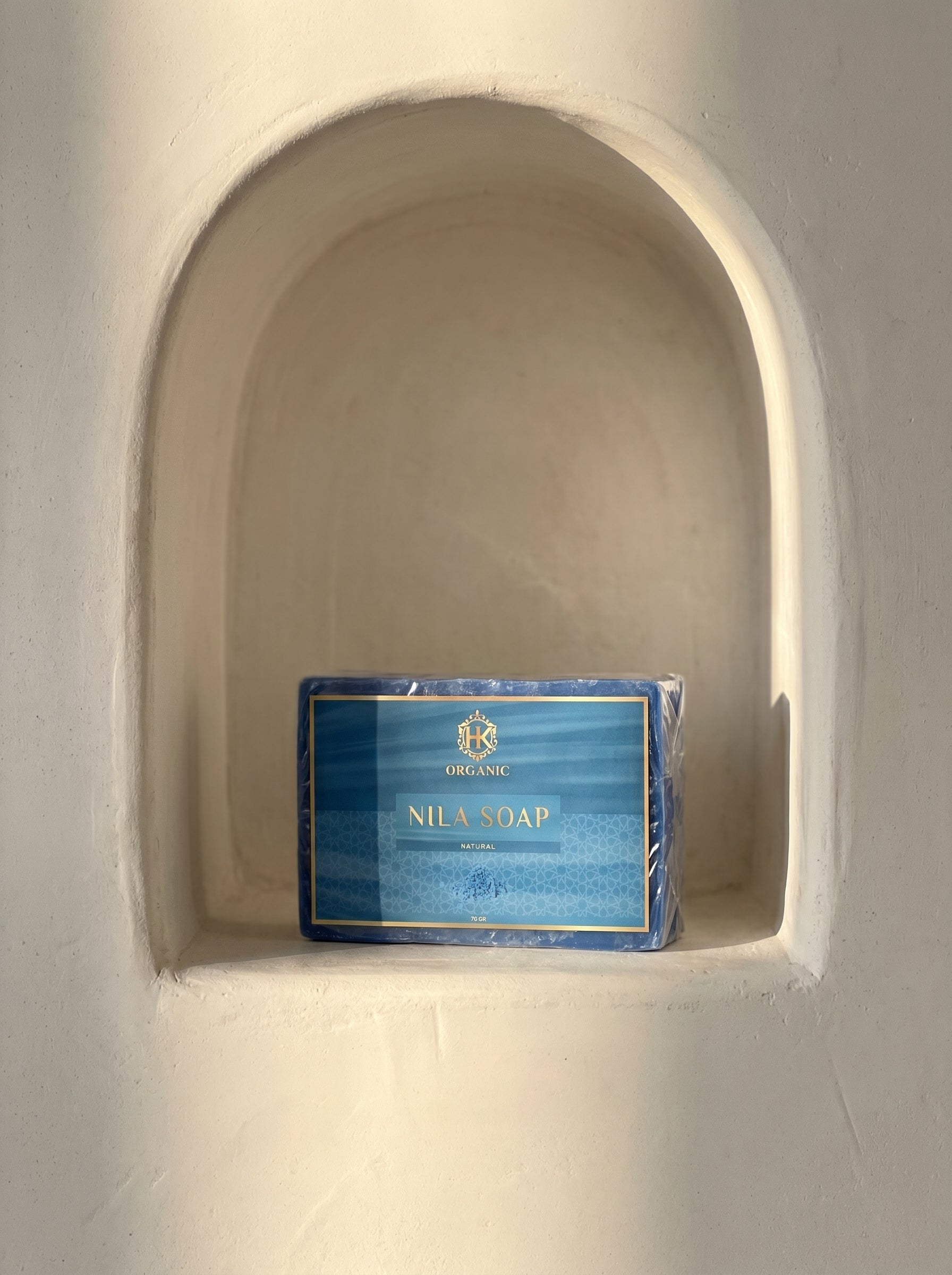 Packaged soap bar in a recessed wall niche
