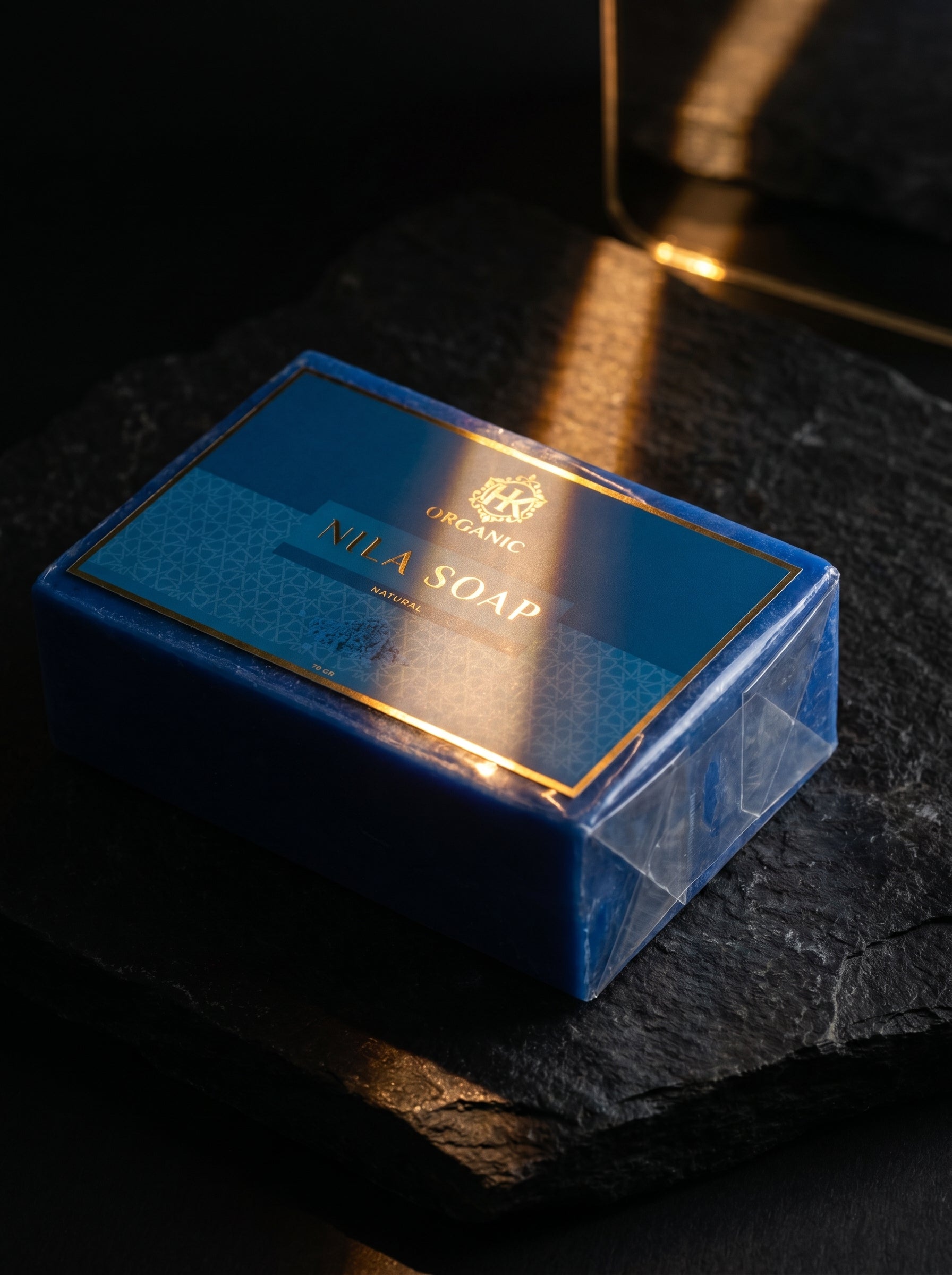 Blue soap packaging with 'Nila Soap' branding on a dark surface
