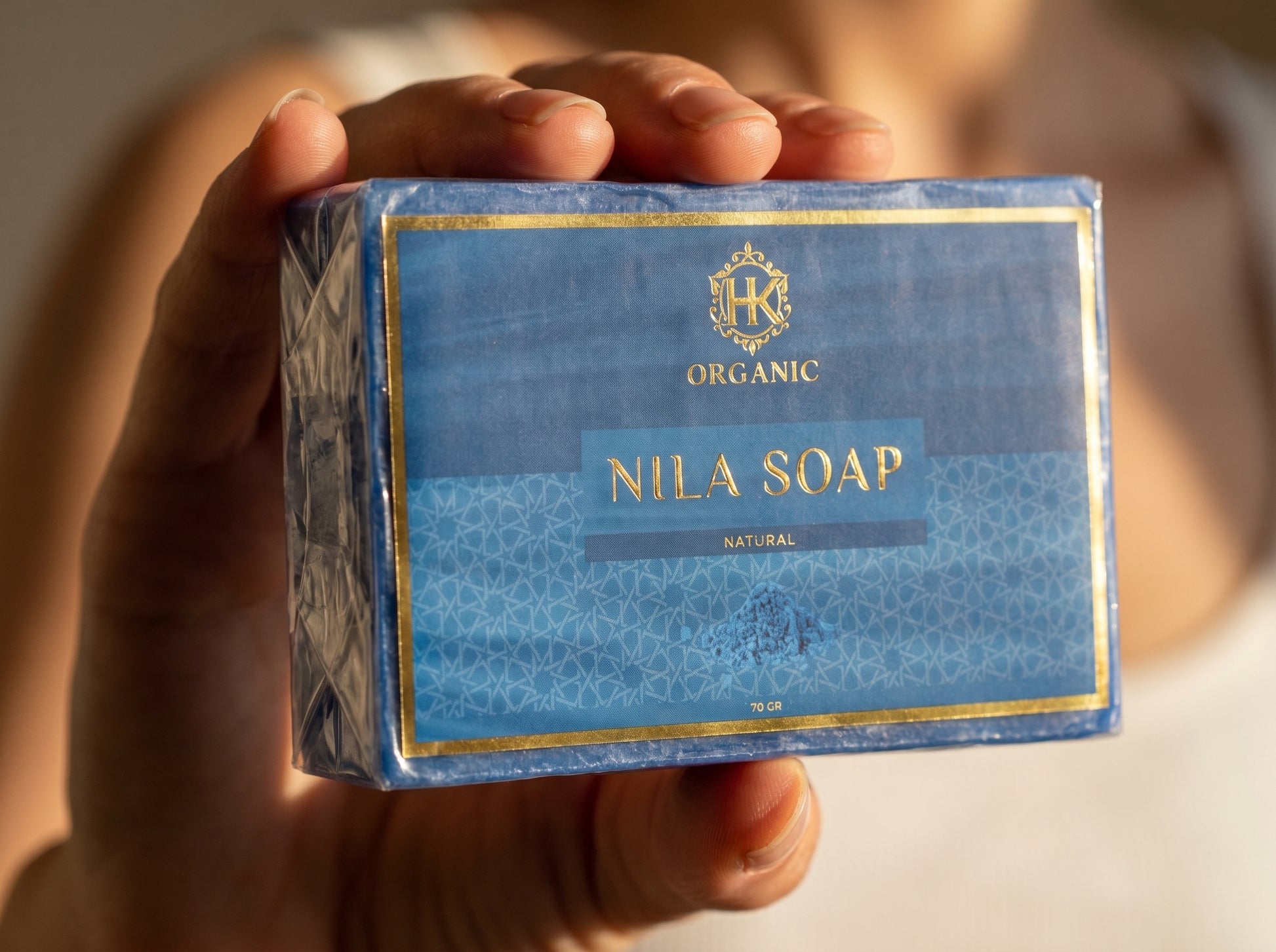 Hand holding a box of Nila Soap with visible branding