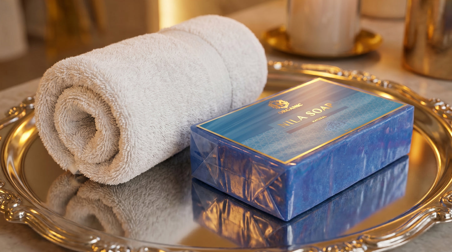 Rolled towel and blue soap bar on a metallic tray