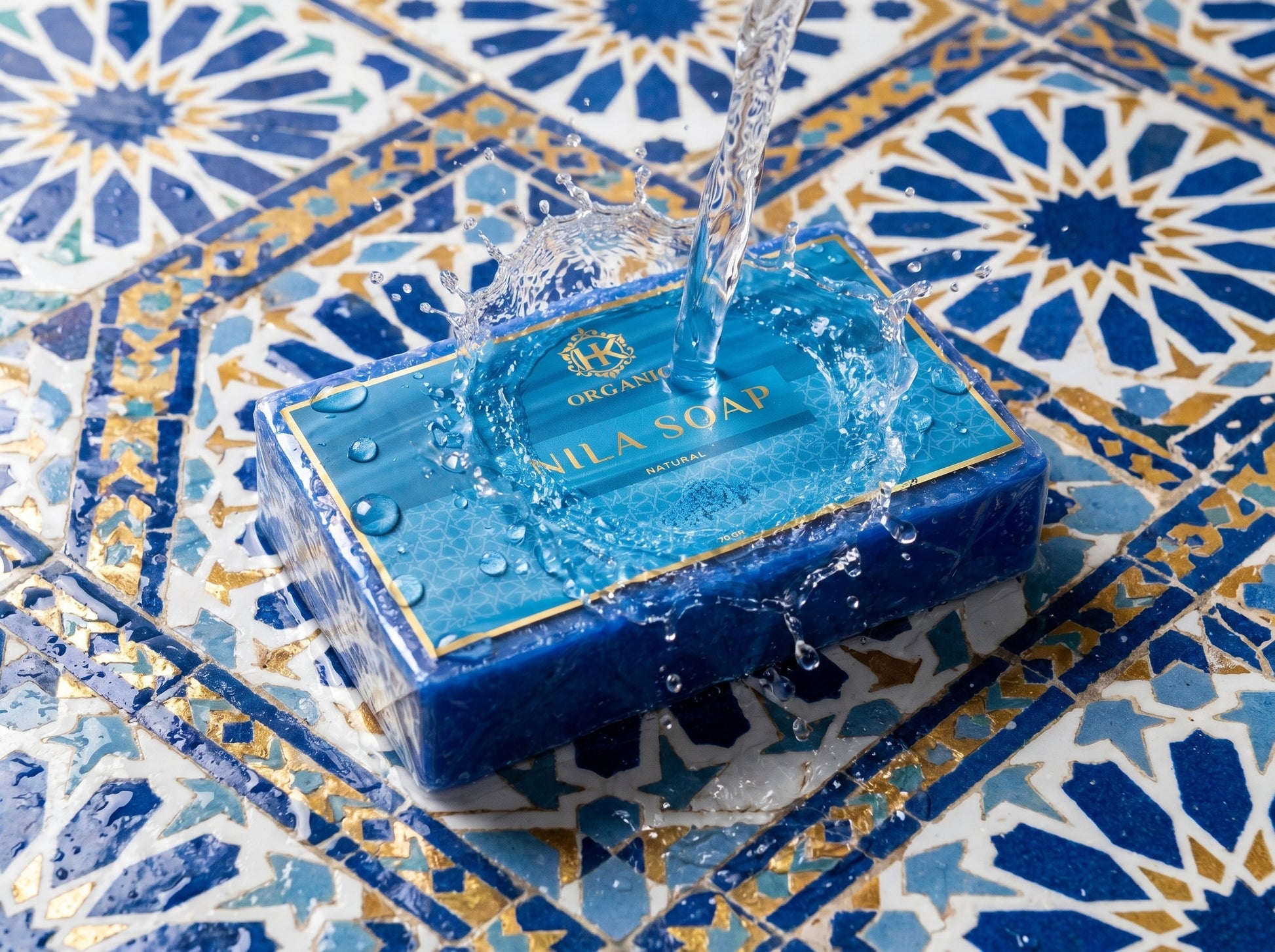 Blue soap bar with clear packaging on a decorative tile background