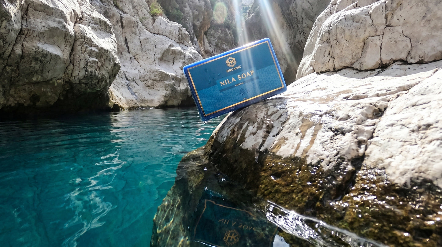 Nila Soa product on a rock by a body of water