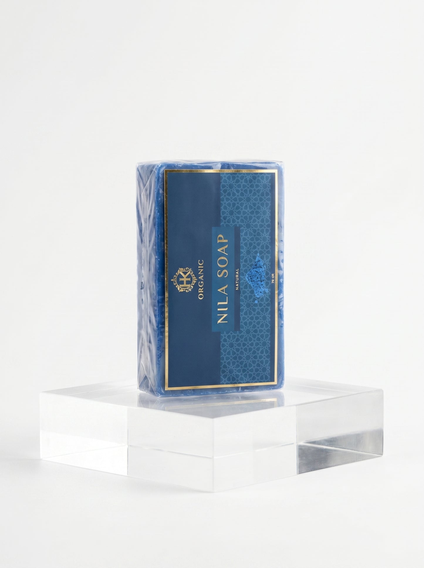Nila Soap bar in a blue packaging on a clear stand with a white background