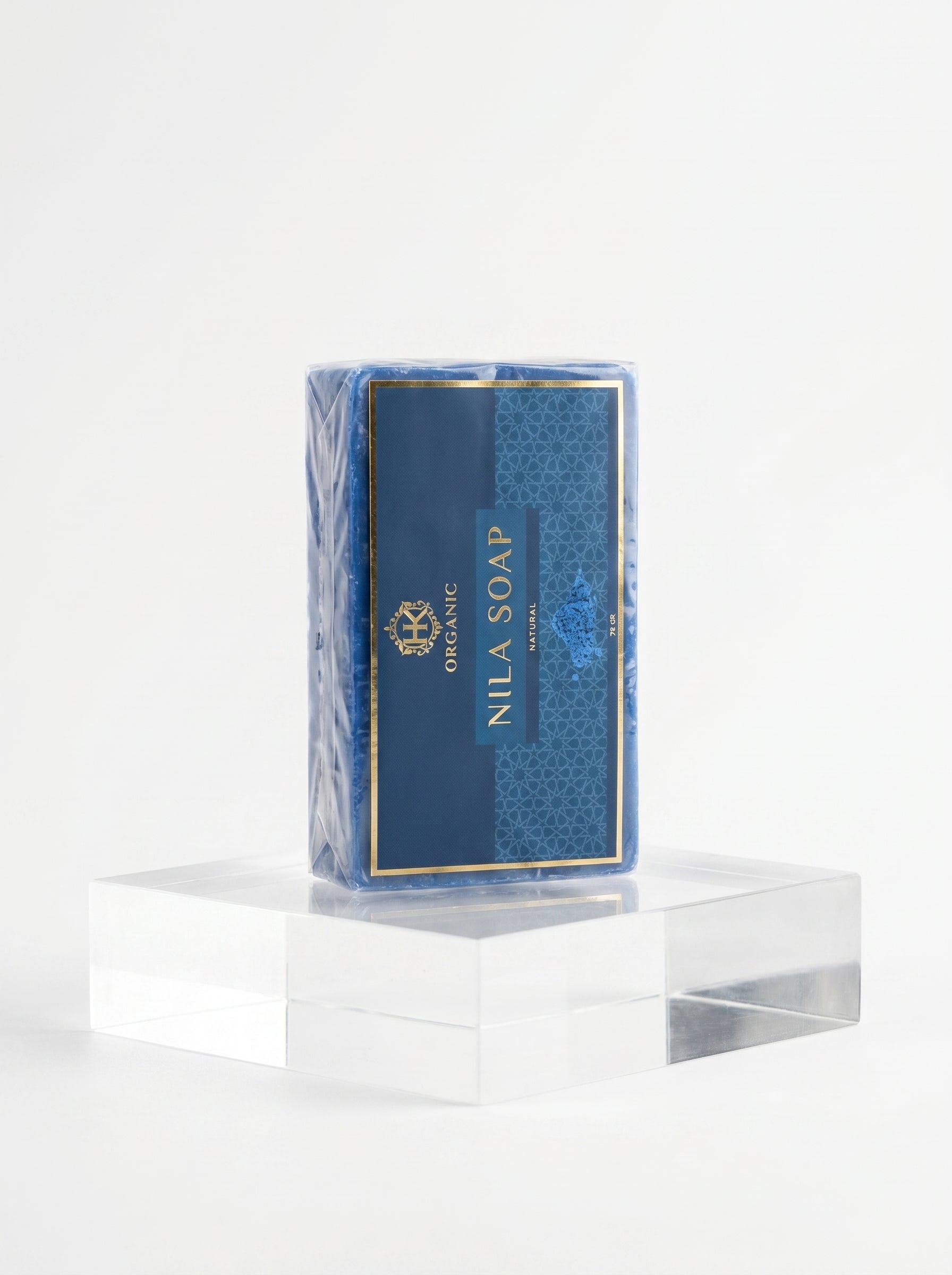 Nila Soap bar in a blue packaging on a clear stand with a white background