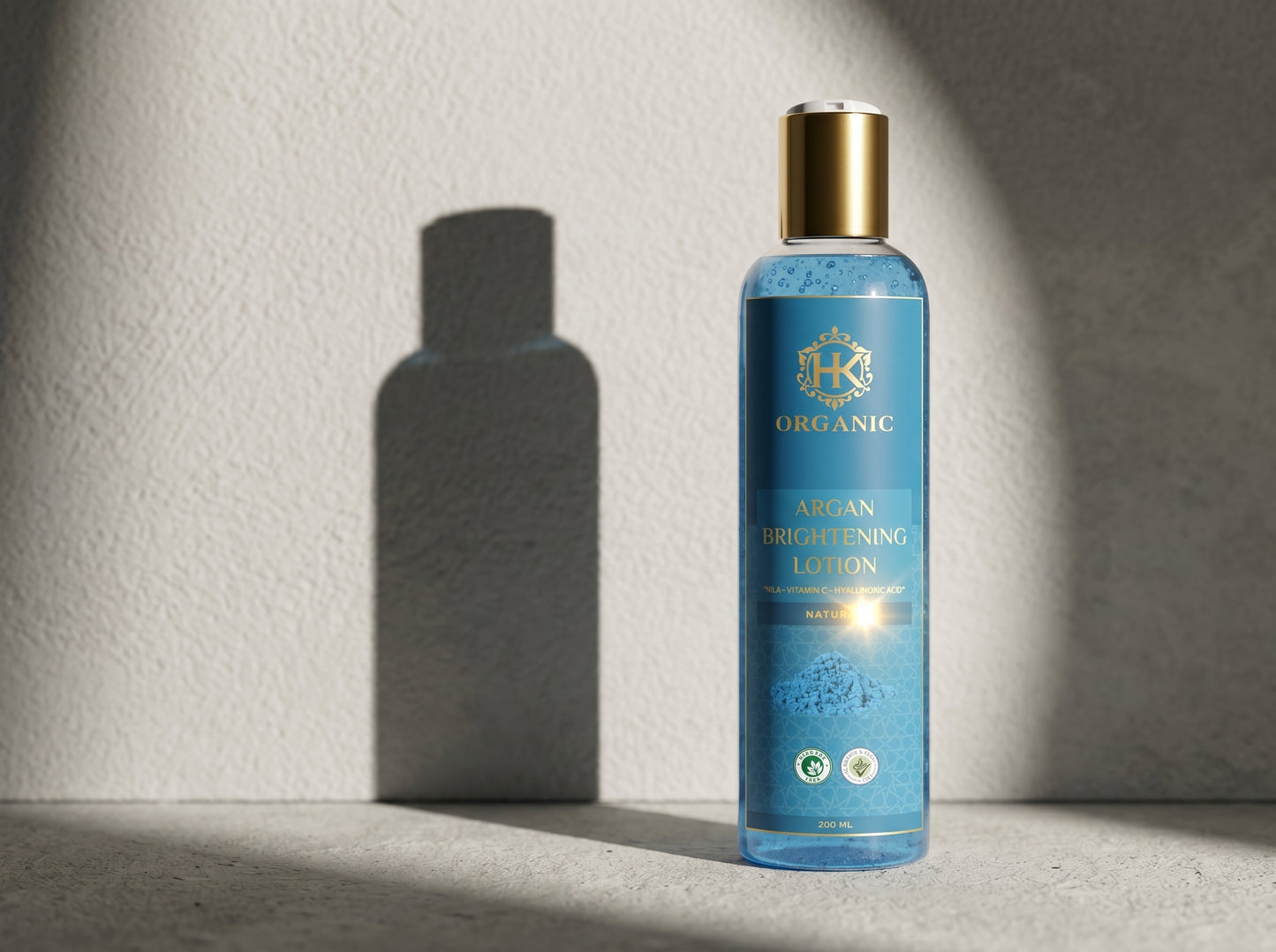 Blue lotion bottle with gold cap on a light gray background