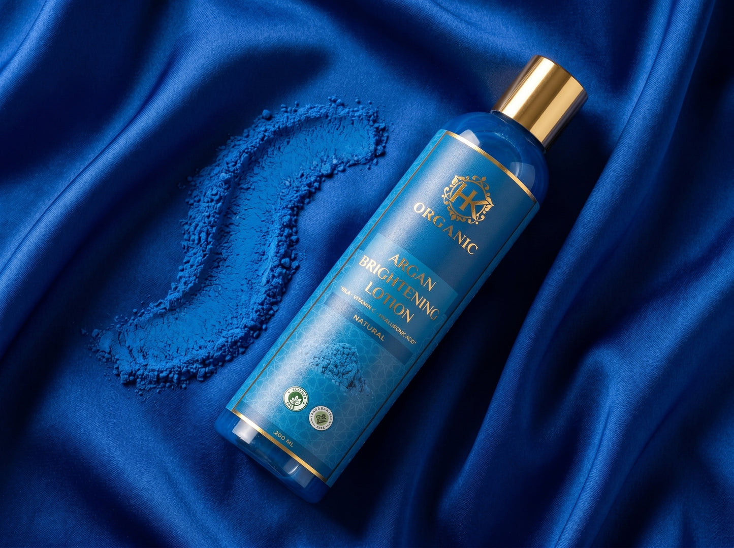 Blue bottle with gold cap on a blue satin background