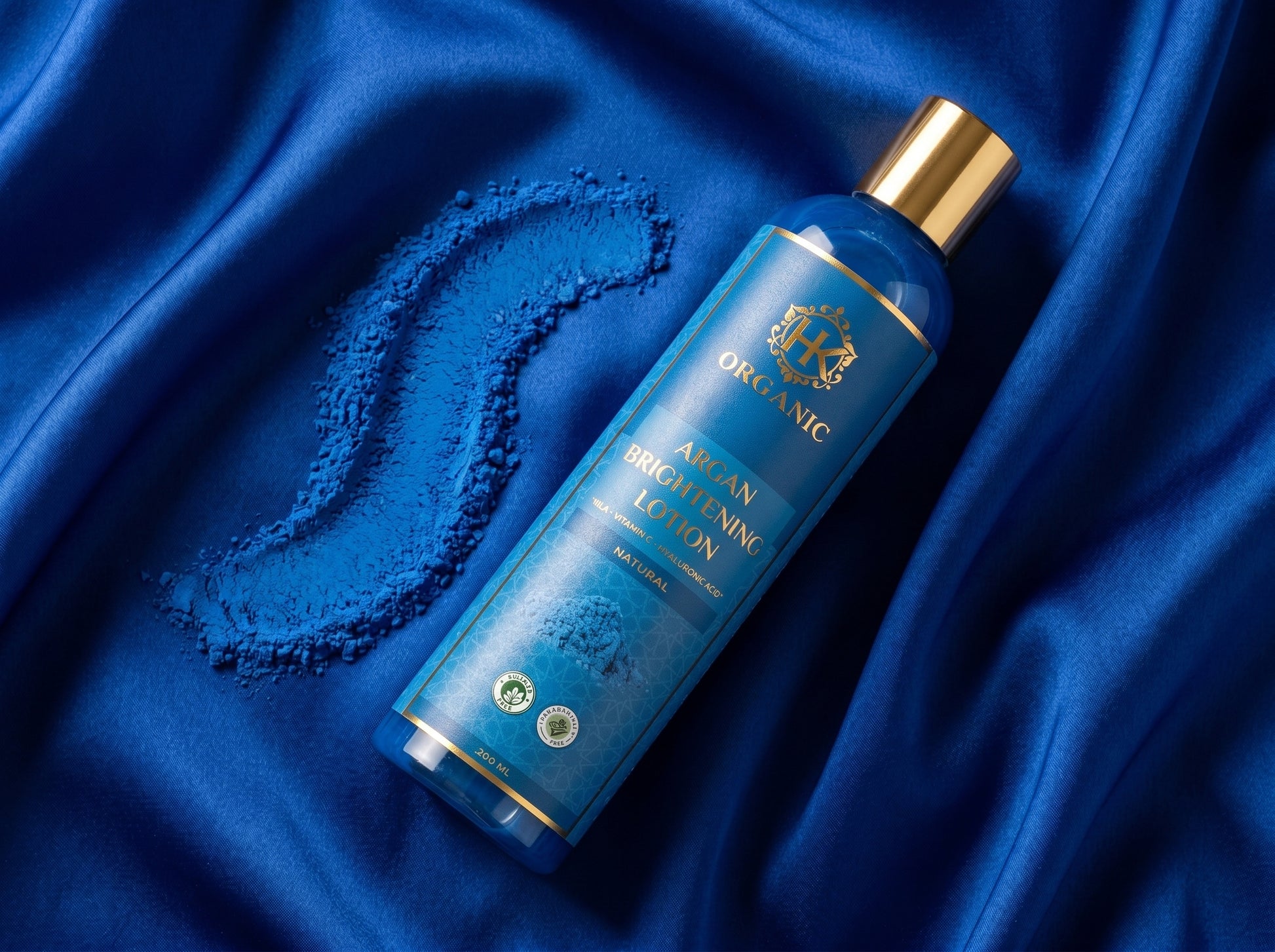 Blue bottle with gold cap on a blue satin background