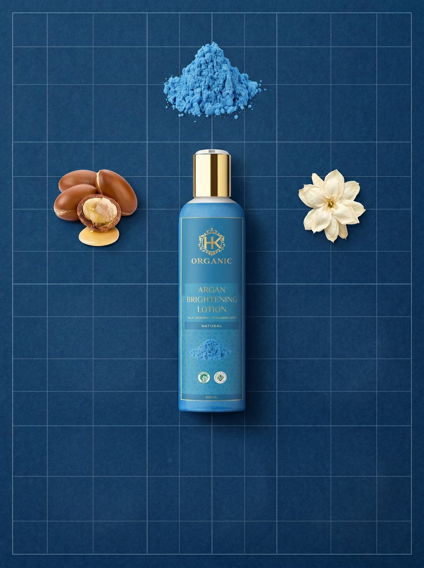 Blue bottle of lotion with argan oil, flower, and powder on a blue grid background