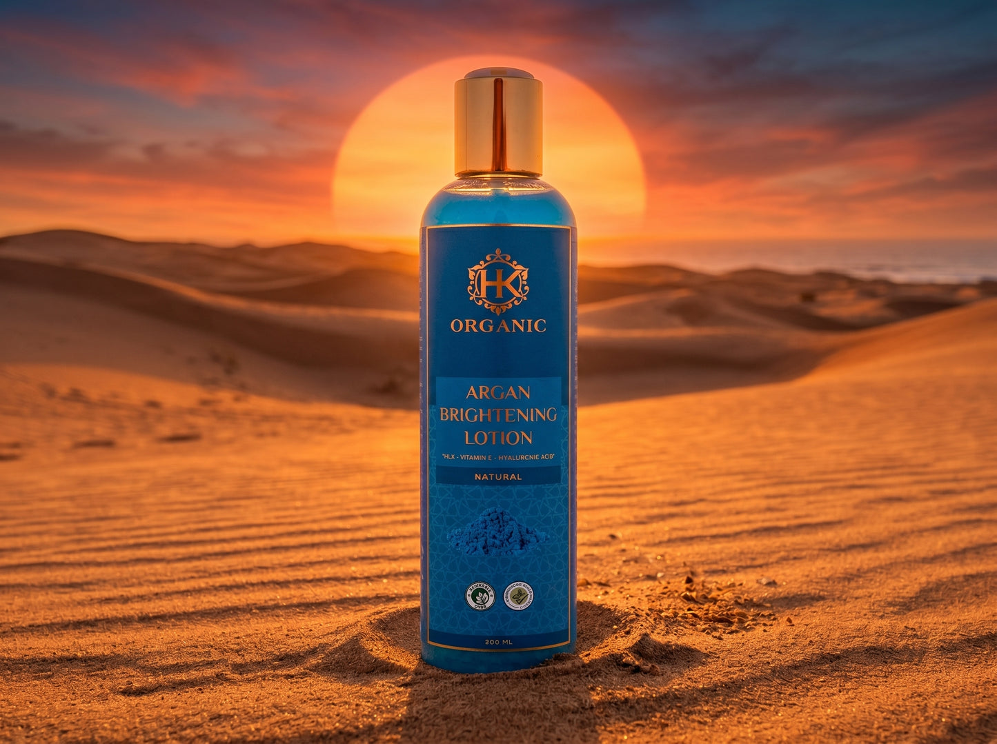 Blue bottle of argan brightening lotion with a sunset in the background